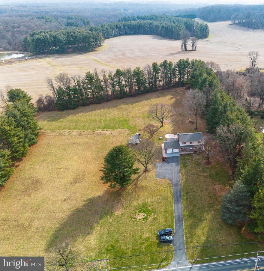 ********************OFFER DEADLINE SUNDAY 2/18 AT 9AM********************
Country charm with modern flair and stunning views!  This meticulously updated home offers the perfect blend of rustic charm and modern style. The picturesque property is nestled on a sprawling 3 acre lot  overlooking a tranquil pond situated just across the street. The back yard is your private haven for outdoor living, featuring an expansive 1500+ square foot sidewalk and natural stone patio constructed in 2022 and a fire pit area perfect for entertaining. LVP flooring in the spacious living room greet you, and the updated kitchen with a large island and dining area (2020) will wow you. Wood stove in family room adds warmth and character, with updated mantel and insert. New LVP in enclosed porch and laundry/mud room.  Upstairs you will find 2 recently renovated full baths, and spacious bedrooms with original hardwood floors and ceiling fans.  Primary bedroom includes en-suite bath.  The basement features a newly finished rec room  and lots of room for storage. The home sits far back from the road, offering a long driveway leading to the two car garage and accessible shed adjacent to driveway. Additional updates include fresh paint (2020-2024), roof/gutters, French patio doors, interior doors, lighting/fans/electric in first floor, Andersen windows (2020), and appliances, water heater and softener and septic line/access (2017). Schedule your tour and let the beauty of this countryside escape capture your heart.