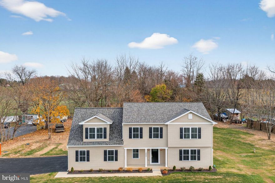 Imagine being the first family to settle into this newly constructed 4BR/2.5BA Colonial located on a sprawling lot in the quiet farming community of Union Bridge.  Pull into the double wide driveway, park in front of the two car garage, make your way past the newly planted landscaping, and open the door into your forever home.  Step into a home filled with natural light, recessed lighting, wood flooring, and the open main floor plan homeowners are seeking.  The main floor offers a large family room with a stacked stone wood burning fireplace, a half bath, mudroom/laundry room with access to the garage, and an open kitchen and dining area.  The kitchen boasts plenty of cabinets, a separate pantry closet, stainless steel appliances, sleek quartz countertops with a complimenting tile backsplash, a deep stainless sink under a window, and a large island with pendant lights and breakfast seating.  On the second floor is an open space ideal as an office or child's play area, three sizable secondary bedrooms, a full bath, and a grand primary suite.  The primary boasts a grand sized bedroom with a large walk-in closet, and a private en suite offering a free standing soaking tub, a double sink vanity, a large walk-in shower, and a linen closet.  The lower level offers you the opportunity to create additional living space to accommodate your family's future needs. From the kitchen step outside to a newly constructed deck that overlooks tons of green space and possibilities.  This home is move-in ready with so much to offer new homeowners and is located nearby shopping, restaurants, and commuter routes.