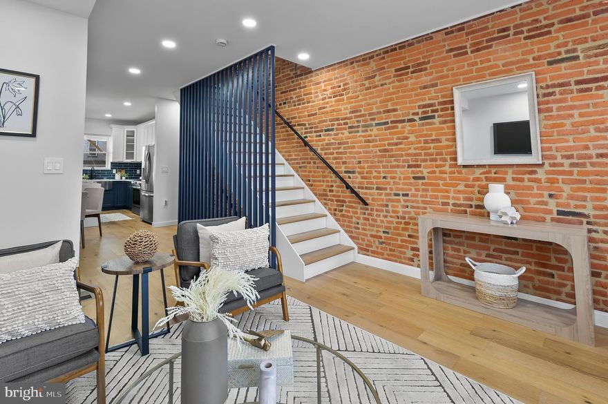 Welcome to 3306 E Lombard Street — Where High Design Meets Everyday Comfort

This fully renovated 3-bedroom, 3.5-bath rowhome in East Baltimore checks all the boxes for a buyer who wants stylish finishes, smart design, and walkable city living without the noise or hassle.

Step into a sunlit main level featuring rich hardwood floors throughout, a sleek electric fireplace, and a modern metal slatted accent wall that brings personality to the space. The kitchen is a true showpiece, designed for both beauty and function — complete with a dramatic waterfall island, drawer storage, and custom lighting that creates the perfect mood for anything from brunch to wine night.

Upstairs, you'll find two spacious bedrooms, each with ceiling fans and great closet space, plus two full bathrooms with automatic lighting and high-end finishes. The top floor even includes a private deck — perfect for enjoying your morning coffee or watching the sun set over the city.

The fully finished basement offers a third bedroom, another full bath, and a flexible space ideal for guests, a second living room, or your dream home office setup. A convenient half bath on the main floor makes entertaining easy, and every detail in this home feels thoughtful and elevated.

While the home offers street parking, you'll quickly fall in love with the walkable neighborhood, where Patterson Park, local cafes, shops, and restaurants are just minutes away. This block is quiet, charming, and ideal for anyone craving a mix of city energy and personal peace.

Best of all, this home qualifies for Baltimore City grants for first-time buyers, making it a smart and stylish move for your future.

Ready to fall in love? Schedule your private tour of 3306 E Lombard Street today.