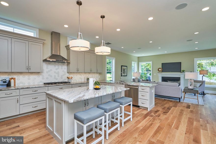 Stunning - NEW HOME  5,024 finished sq ft - IMMEDIATE Delivery** High Quality, Thoughtful Builder - provides many upgrades other builders just don't!!  Floor plan in Documents **4 Lavish Levels - 6 bedrooms, 6 1/2 baths!!   Lovely open floor plan - 10ft ceilings - main, 9ft ceilings 3 other levels ** White Oak REAL hardwood floors main level, upper hall and Primary Bedroom** Spacious main floor Office/music room/ grandma room**Decorator lighting IN & OUT**Huge Kitchen - Quality cabinets in kitchen made up of cabinets with slide outs & tons of drawers for easy storage.   GE Profile Stainless Appliances including convection microwave and convection oven, Tuscan Fantasy Marble counters, Unique High-end tile backsplash, and under cabinet lighting** Primary Bedroom is Bright & Spacious  - 2 walk-in closets w/custom shelving* *Primary bath is Divine - split vanities, high-end lighting, Stunning zero entry shower has elegant tile work**  Upper Level 2 is amazing for guests or older kids - has full bath**Lower Level has 2nd Family room, Bedroom & full tiled bath **  Recessed lighting throughout!!  Front Stone front foundation & retaining walls will have accent lighting** Side Partially  Covered Porch w/Trex type decking** Wrap around Front porch ** 2 Quality HVAC systems, 4 thermostats**Concrete Driveway and Garage door opener** Friendly and very Quiet community - many new homes**  Gorgeous Sunsets from this high point in Fairfax County **2 NEW homes built side by side - 7017 is 4,769 Sq. Ft. for $1,475,000