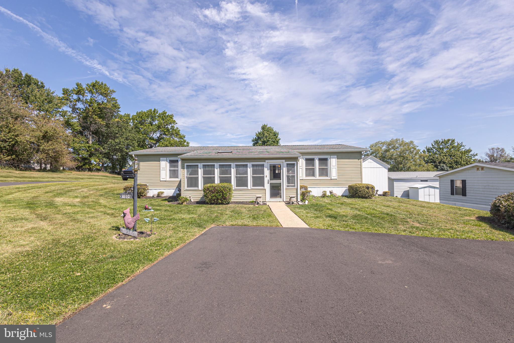 Neshaminy Falls is an Active 55+ Community located in the heart of Montgomery Township and close to all major routes, restaurants, shopping, Costco, Hospitals. You Want it or Need it? You can find it very close by! This 3 Bedroom, 2 Bath 1344 square foot manufactured home features a corner lot, spacious sunroom at the front of the home with 12 updated windows! Nice Sized Deck out back with retractable awning. Plenty of shade when needed! Large Living Room with Bay Window and Nice Sized Dining Room with Glass Sliders to your Deck. Updated Kitchen with all stainless appliances, recessed lighting, ample cabinetry! Dedicated Laundry Room off the Kitchen with Side Exit to yard and almost new 2 Year old Shed for extra storage. Primary Bedroom has double closet and a nice sized Bath with Walk In Shower. 2 Additional Bedrooms share a Main Hall Bath with newer Jacuzzi Walk In Tub. This home has new Heat and A/C in 2023—Roof, Vinyl Siding, Hot Water Tank, Deck, have all been replaced during this seller’s ownership. Sewer and Trash included in the ground rent. This is a well maintained and affordable home! Nice Driveway out front for 3 Cars! Schedule your visit today. This home is surprisingly spacious and is a lot of bang for your buck at $218,000!