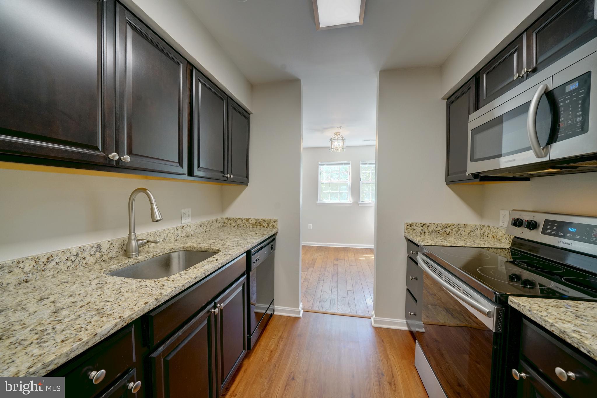 Available immediately! Updated TOP floor (3rd level) condo in Montgomery Run. 2 bedrooms and 2 full baths. Unit features vaulted ceilings in living room with walkout to rear deck/balcony. Hardwood floors in dining room plus updated laminate flooring in foyer, kitchen and both bathrooms. HVAC system has been updated. Upgraded kitchen with updated dark wood cabinetry including soft close drawers, granite countertops, Stainless Steel stove and stacked front loading washer / dryer. Large primary bedroom with vaulted ceiling, walk in closet and full en-suite bathroom. Water and HOA fees included in rent. Secured (locked) entrance in building with interior access to front door of condo. Community has outdoor pool, playground and open common area space. Walk to Shipley's Grant shops, restaurants. Convenient access to 100, 95, 295 and 29.
