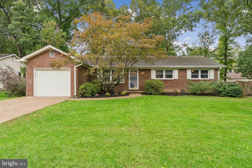 VA Assumable Mortgage Available - Call for More Details. Welcome home to this updated one level home in sought after Montclair! The home offers 3 main level bedrooms and 2 full bathrooms plus a fully fenced rear yard and a one car attached garage with concrete driveway. Updates throughout include: hardwood floors, overhead lighting, ceiling fans, renovated bathroom, replacement windows (less than 10 years old), roof (about 12 years old), HVAC (approximately 5 years old), shed (2020), water heater (less than 7 years old), stainless steel appliances and updated interior door knobs.  Since 2018 grading work has been completed around the house  to include a French drain with gravel backfill, 2 sump pumps and buried downspouts - this all helps keep the rear yard usable year round. Concrete lead walk surrounded by mature landscaping leads to the front entrance with a storm door. Walk into a foyer with coat closet and recessed lighting. Open Living Room boasts beautiful hardwood floors, ceiling fan with light & recessed lighting. Separate Dining Room features an upgraded ceiling light fixture, recessed lighting, hardwood floors and access to the Kitchen.  Fully equipped Kitchen offers stainless steel appliances, granite counters, custom backsplash, rear facing window over sink and extra large pantry. Family Room offers access to the attached garage as well as access to the deck. Laundry located inside the Garage.  In addition, the Family  Room has a ceiling fan with light and  wood burning stove fireplace with brick hearth. Primary Bedroom has three windows, hardwood floors, ceiling fan with light, spacious closet and attached full Bathroom with upgraded vanity, ceramic tile flooring, rear window and shower/tub with tile surround. Two guest bedrooms both offer two windows, hardwood flooring, ceiling fan with light and closets with built-ins. Renovated full Bathroom offers LVP, vanity, and shower/tub with custom tile surround. Attic with pull down stairs in hallway. Fully fenced rear yard with newer gates and some newer sections. Amenity filled Montclair community offers beaches, common areas, tot lots, parks and dog parks. Easy access to commuter routes and more!