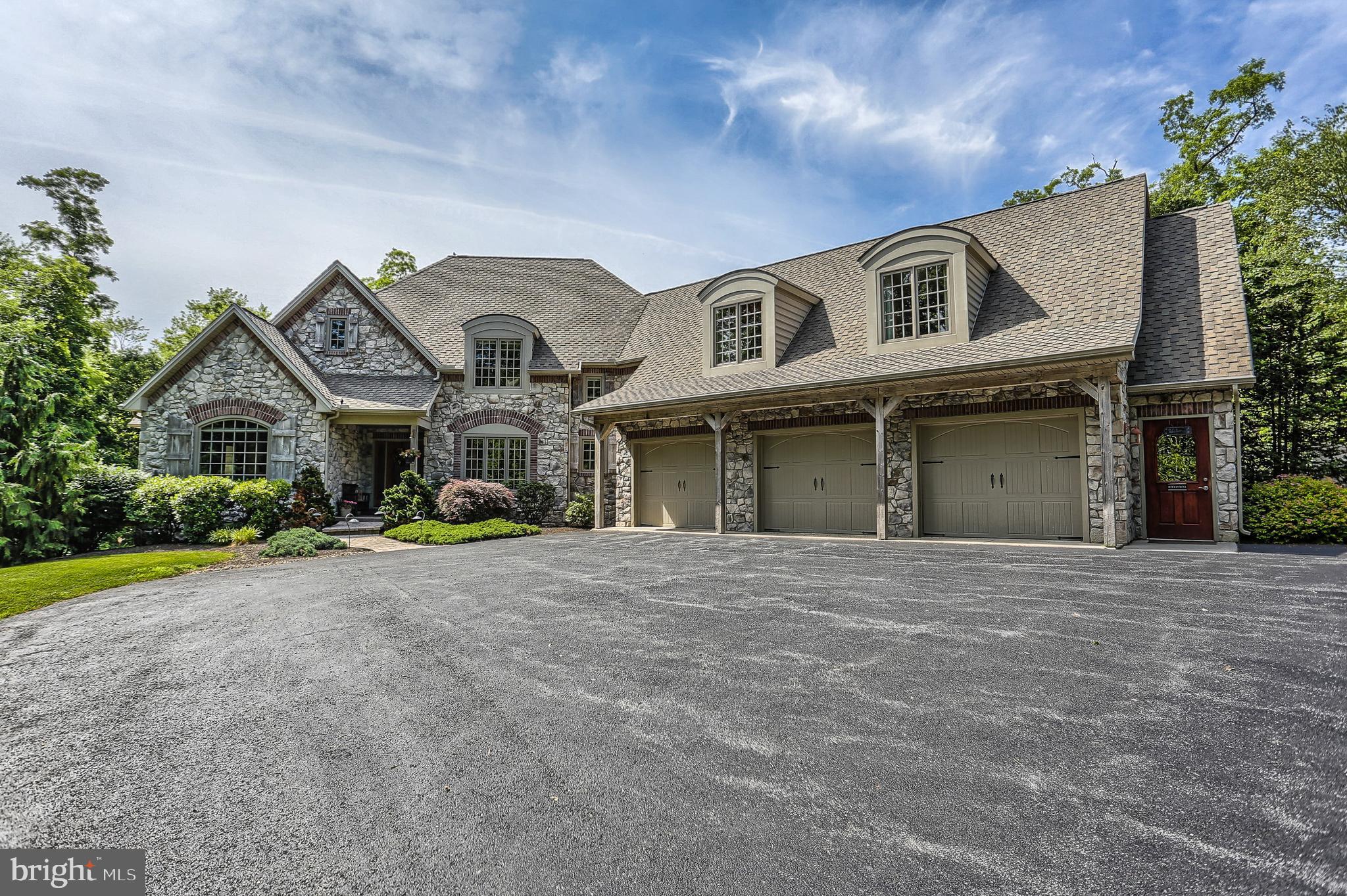 The possibilities are endless in this incredible French country style home, situated on 13.5 sprawling wooded acres! Meticulous attention has been paid to every detail in this well appointed home, built by premier custom home builder, Musser Home Builders and used as their model home. The chef s kitchen features granite countertops, stainless steel appliances including a double wall oven, walk-in pantry, and counter island which seats up to five.  The spacious family room has 17  ceilings and a cozy stone fireplace.  Master suite is located on the main floor of the home and is complete with a fireplace, jetted tub, custom tile shower, hickory hardwood floors, private balcony, and access to the pool.  Also located on the first floor are several rooms offering opportunity for spare bedrooms or office space for a home based business. Second floor efficiency apartment offers opportunity for in-laws quarters or extended stay guests and has a full kitchen, fireplace, and it s own private entrance. Rustic lower level has a custom built bar with concrete countertop, custom maple cabinetry, full bathroom, and gameroom.  Privacy and serenity abound in the backyard, perfect for enjoying the hot summer days and nights! Stunning outdoor entertaining area boasts a fiberglass swimming pool, hot tub, and relaxing cabana area. Large 50  x 30  outbuilding offers heat, water, and electric. Truly remarkable custom home, you must see to appreciate!