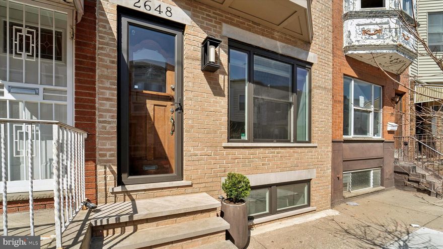 2648 S Camac St may be the perfect balance of tasteful updates, preserved character, and convenience of location you’ve been seeking for your new home. On a quiet block in the heart of Lower Moyamensing, this classic brick-front row has been impeccably updated and meticulously cared for while retaining much of its original charm. After admiring the dapper exterior with vintage Tofani Star door, you’ll be delighted by the cheery original tiled vestibule. Enter the open living space with oak flooring, detailed moulding and trim work, bathed in light from the extra-large front windows. The kitchen is a chef’s dream with high-end appliances (Bosch stove, Kitchen Aid cooktop with venting hood, LG fridge & dishwasher), recessed and pendant lighting, and ample prep space on the charcoal countertops. The rear yard is walled for privacy and has plenty of room to grill ’n' chill. Upstairs are three light-filled bedrooms and the tastefully-updated bathroom with marble-tiled shower. The large front bedroom features recessed lighting, ceiling fan, custom built-in wardrobes and a double closet. The floors in the hallway are beautifully-refinished original pine; the bedrooms are cozily carpeted. Laundry is in the basement, which is clean and dry, and great for additional storage. Oh, and this beauty has got "brains" too, with smart light switches, Nest thermostat, wired Ethernet to all rooms, and security system. The HVAC is 3 years old and all plumbing and electric were replaced when renovated. This location is around the corner from Marconi Plaza (with volleyball, baseball, and kickball leagues, spring thru fall) and the Broad Street Line, has easy on-off access to I-76, and is a quick walk to the sports complex for all the Philly sports fans! Also lots of shopping options on Oregon Avenue, and a short stroll to all the incredible restaurant and shopping highlights of East Passyunk. Monthly parking available a block away for a fee. Come visit, we welcome you!