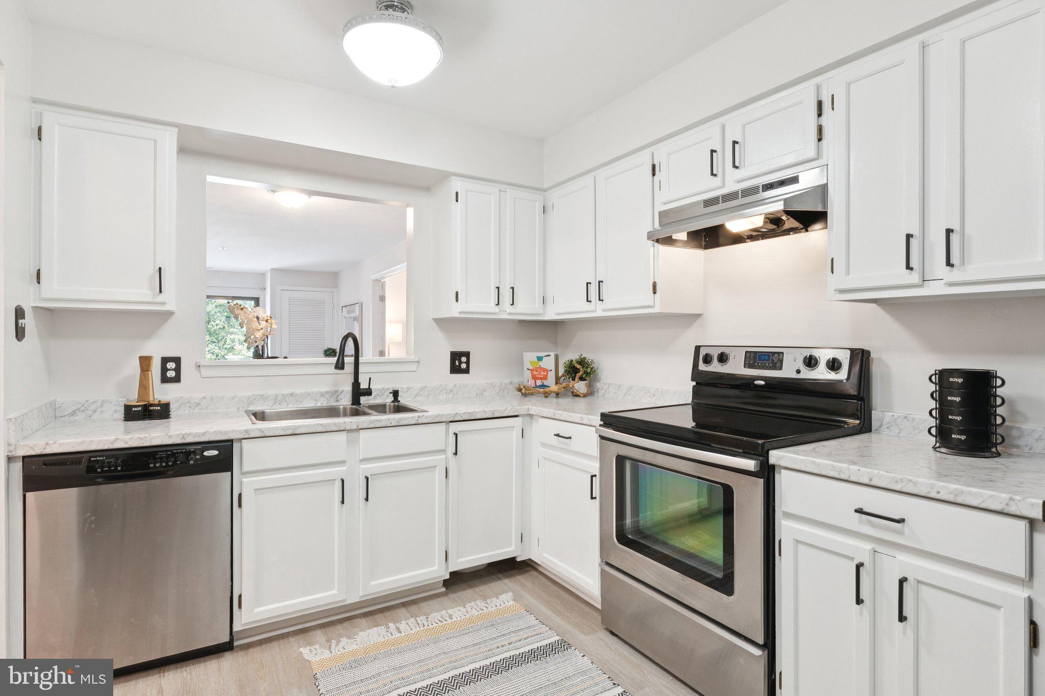 Welcome to your Annapolis retreat—Unit #211 is a bright and breezy 2-bedroom, 2-bath condo with a den, offering the largest floor plan in the community with over 1,150 sq ft. Located in the vibrant and active 55+ community of Heritage Harbor, this home is just steps from the South River and offers an exceptional blend of comfort, style, and resort-style amenities. Inside, you'll find an open layout with brand NEW wide-plank LVP flooring throughout, creating a seamless flow from the spacious living and dining areas to a private balcony perfect for relaxing. The den offers additional living space and has brand new French doors to extra privacy. The updated kitchen features white shaker cabinets, carrara-look countertops, and stainless steel appliances. The primary suite offers a walk-in closet, access to the private balcony, and a beautifully renovated en-suite bath. A full-sized NEW washer and dryer are included in-unit for added convenience, plus one assigned parking space also conveys with the unit. Other updates include fresh paint throughout including walls, ceiling, and trim. The building has recently installed a new elevator and carpet throughout the hallway. Residents of Heritage Harbor enjoy access to a wealth of amenities including pools, tennis and pickleball courts, a 9-hole golf course, kayak launch, boat slips on the South River, a clubhouse with dining, and even RV and boat storage on-site. Whether you're enjoying a quiet morning on the water or an active afternoon on the courts, Unit #211 offers the perfect balance of relaxation and recreation in a picturesque Annapolis setting.