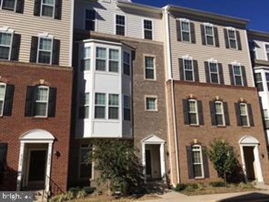 Experience refined living in this spacious 2,702 sq ft brick-front townhome with a 1-car garage. The elegant open-concept design features stunning hardwood floors throughout the main level. Enjoy cooking in the gourmet eat-in kitchen, complete with a granite center island, 24" cherry cabinets, and a large pantry. The luxurious master suite offers dual walk-in closets for added convenience. Parking is available both on the street and in the rear driveway. Just half a mile from the Metro for easy commuting.