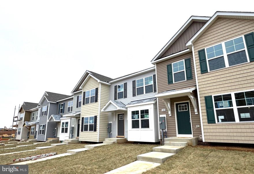 Brand New Townhomes in The Communities of Burwell! Everything you want, already built in.
Nearly complete for quick delivery, these 2-level townhomes offer 1,440 sq. ft. of thoughtfully designed living space featuring 3 bedrooms and 2.5 baths.  The open main level welcomes you with luxury vinyl plank flooring, a spacious family room with bump-out, and a beautiful kitchen complete with granite countertops, a large island, separate breakfast bar, pantry, and stainless steel appliances—perfect for everyday living or entertaining.  Upstairs, the primary suite impresses with a vaulted ceiling, walk-in closet, and spa-inspired bath featuring a tile shower with glass door and double vanity. Two additional bedrooms and a full hall bath provide plenty of space for family, guests, or a home office.  Enjoy outdoor living on your 10x12 rear deck, plus the convenience of ample overflow parking just steps away.  The builder is also offering closing cost assistance!