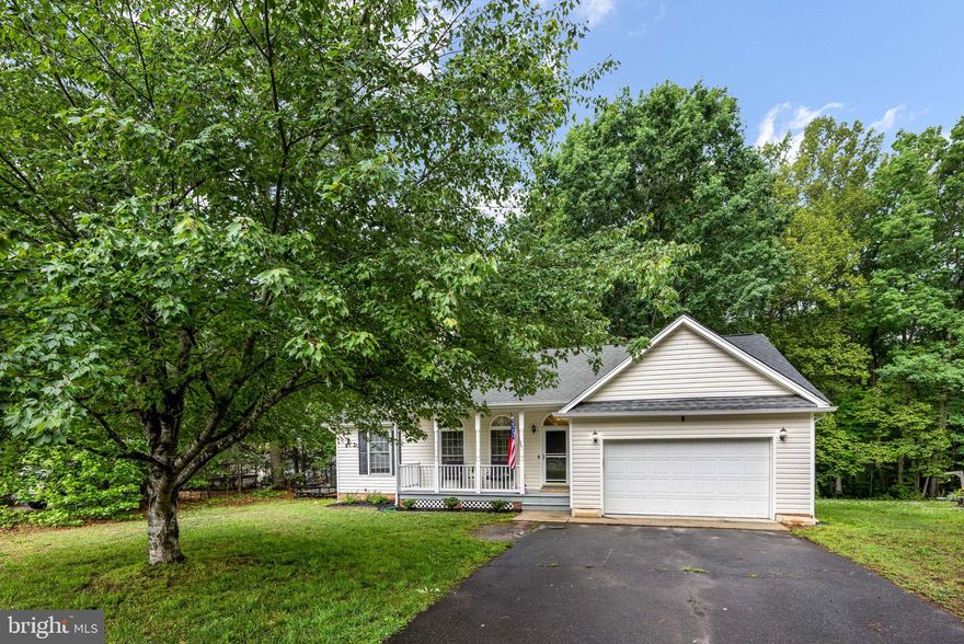 Welcome home to 18120 Bridlewood Lane, a charming and beautifully maintained rambler nestled on a private, tree-lined lot in Ruther Glen! From the moment you arrive, the inviting covered front porch and crisp curb appeal welcome you inside to a sun-drenched, open-concept living area. The main space boasts gorgeous vaulted ceilings, a chic modern ceiling fan, rich luxury vinyl plank flooring, and a striking accent wall complete with a cozy fireplace. It flows seamlessly into the bright kitchen, which comes fully equipped with sleek stainless steel appliances, pristine white cabinetry, and a timeless subway tile backsplash.

The spacious primary bedroom serves as a true retreat, offering high vaulted ceilings, a serene deep-green accent wall, expansive closet space, and a private en-suite bathroom. Step through the dining room's sliding glass doors to enjoy outdoor living at its best on the roomy rear deck—ideal for summer grilling and entertaining. The fully fenced backyard provides a peaceful, wooded backdrop for ultimate privacy and includes a matching storage shed for extra convenience.