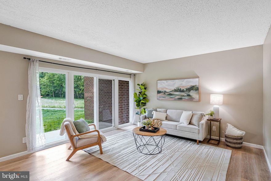 Welcome home to Hunter Woods Village! This bright and airy entry-level condo is the perfect blend of style and comfort, offering a sophisticated retreat in one of Reston's most vibrant communities. Inside, luxury vinyl plank flooring and thoughtful design choices set a stylish tone throughout. The spacious, light-filled living room features floor-to-ceiling windows that flood the space with natural light, flowing seamlessly into the adjacent dining room - perfect for everyday living and entertaining alike. An updated modern kitchen impresses with stainless steel appliances, sleek granite countertops, and a stylish tile backsplash. Down the hall, the generously sized primary bedroom offers plush carpeting and a peaceful retreat, complemented by a tasteful hall bathroom. Step outside through sliding doors to your covered patio, surrounded by lush green space and beautifully maintained common grounds - a peaceful escape right outside your door. Convenient in-unit laundry, two included parking passes, and two guest parking passes make everyday life effortlessly easy. Residents enjoy access to one of Northern Virginia's most sought-after master-planned communities, known for its perfect balance of nature and convenience - with amenities including basketball courts, a beach, bike trails, common grounds, a community center, jog/walk paths, a lake, picnic areas, an outdoor pool, tennis courts, and over 55 miles of scenic trails. Just minutes to Wegmans, Reston Community Center, Lake Fairfax Park, Dulles Airport, and Reston Town Center with popular dining destinations like Passionfish, Bar Taco, Ted's Bulletin, and Barcelona - plus a vibrant mix of shopping, entertainment, and year-round events. Quick access to Reston Metro Station, Reston Parkway, the Dulles Toll Road, and the Fairfax County Parkway. Schedule a private tour of your beautiful new home today!
