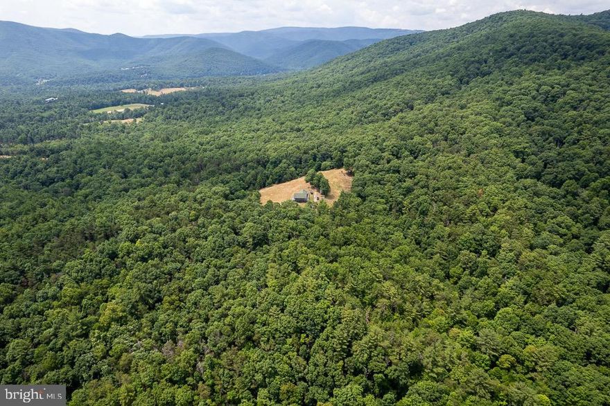 GREAT RECREATIONAL PROPERTY WITH 68 TOTAL ACRES. 100% remote living with National Forest frontage.  Amazing views of the mountains with an abundance of wildlife. Nice home with 3 bedroom and 2 baths. Home has great decks for taking in the views. Access on Right of Way but property has road frontage. GIS is incorrect by not showing National Forest frontage but survey shows frontage.