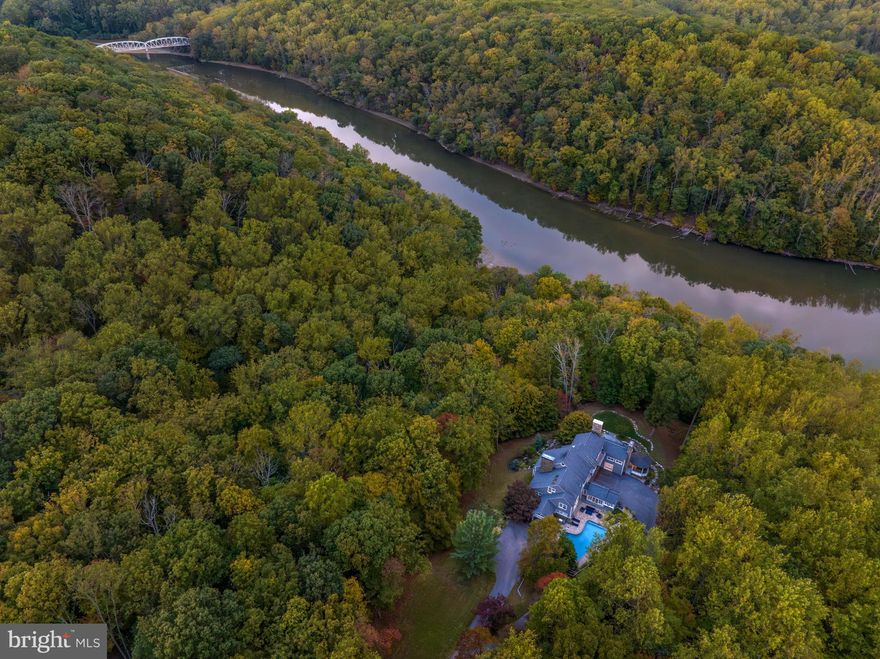 Live authentically. Masterful design and unparalleled outdoor living come together in perfect harmony at Hidden Waters. Perched on 3.28 acres of blissful seclusion, this sensational custom home boasts the only views in the neighborhood of the Loch Raven Reservoir. A luxury oasis comes into view as soon as one approaches the long private drive. A sophisticated and reimagined space for culinary delight opens to a bright and functional living room with a floor-to-ceiling stone stacked fireplace. Relax and soak in the seasons and surrounding views from the breathtaking great room with high ceilings, stylish wooden beams and glassy doors that connect to the back deck built by Lenhoff Builders. The mudroom of your dreams has extensive counter space and storage for all your needs. A plethora of possibilities for gathering with family and friends including the sleek indoor bar or the thoughtfully re-designed gazebo with a new copper roof. A space and place for everyone in any season. Hang out bundled up under the stars by the fire pit on the side patio and lush lawn. Spend your summers lounging by the heated pool surrounded by colorful landscaping. Imbibe with elegance while using a one-of-a-kind wine cellar.  A stunning and expansive study with built-ins, fireplace and French doors makes working from home feel more compelling than ever. The primary suite is a true retreat with its own fireplace and deck as well as a luxurious bath with skylights. The lower level is bright, light and inviting with space for working out or hanging out. A truly unique and hidden gem close to everywhere you want to be. The art of uniting human and home.