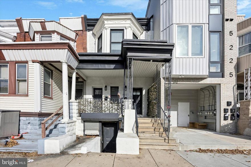 Live in either of the gorgeous, nicely renovated two-bedroom units in this duplex and let the tenant’s rent cover a sizable chunk of your mortgage payment. There’s also a bonus garden-level unit with powder room for a dreamy live-work situation or the potential for additional retail rental income. Take your pick for your home: The first-floor unit has private access to the rear yard while the second floor has a slightly larger main living space. From the well-maintained facade with pretty original bay window, both units have a private entrance; high ceilings with recessed lighting; exposed brick accents; well-appointed kitchens; spacious, stylish baths; and central air. The first-floor unit has wide-plank oak floors throughout, an open floorplan living room and kitchen with marbled quartz island with undermount sink, stainless steel appliances including a five-burner Samsung range and Frigidaire dishwasher, and black beveled subway tile backsplash. Off the hallway with exposed brick wall is the bathroom with large-format porcelain tile floor and tub surround with pennytile accent, a large vanity with drawers, and a floor-to-ceiling storage niche, followed by a good-sized middle bedroom and large rear bedroom with exclusive access to the yard. The second-floor unit has a private staircase with exposed brick wall that opens to the spacious open-plan living space with gleaming new hardwood floors. The living room has a bay window, decorative wall molding and tray ceiling. The super-stylish L-shaped kitchen features black Shaker-style cabinets with gold hardware, marbled quartz countertop with breakfast bar and undermount sink, marble and gold hex tile backsplash, and Samsung stainless steel appliances including a five-burner range and dishwasher. The hall bath has a cement mosaic tile floor, tub with polished textured subway tile surround and transom window and a cage pendant light above the vanity. Mirroring the first floor are the good-sized middle and back bedrooms with nice closets and good natural light. The location just around the corner from 52nd St gives easy access to shopping, dining and public transit.