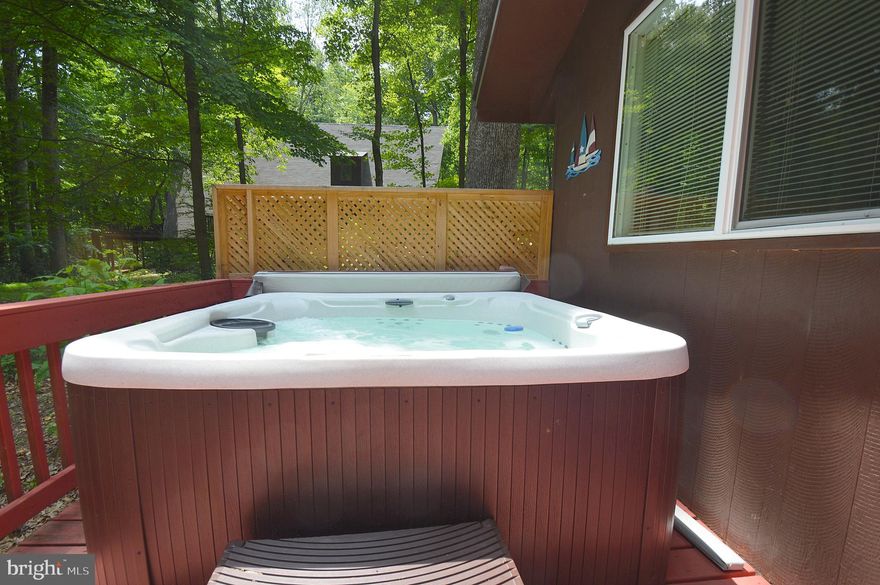 Cash cow minutes from town yet very secluded. Part of prestigious Coolfont Mountainside
Association. This 2 bedroom, one bath has a loft, covered porch and high ceilings 
throughout. Multiple, brand new upgrades such as a 91 jet hot tub, new windows, sliding
glass doors, heat pump, range and dishwasher. Expansive deck backs up into green space, TONS of natural light. Use as a mountain retreat or income producing property. There are current booking should the new owner desire additional income.
Owners have access to community (seasonal) pool/ hot tub/ tennis courts/ extensive trails/ and recreational barn. Only 10 minutes from golfing, horseback riding, paddle boats, totally
renovated Cacapon State Park lodge and its public beach. "Timbers" is located 10 minutes from highway
68 and only a 90 minute ride from Baltimore or Washington DC. Homes in this private community
rarely become available. Book your viewing today as this refuge won't last long!