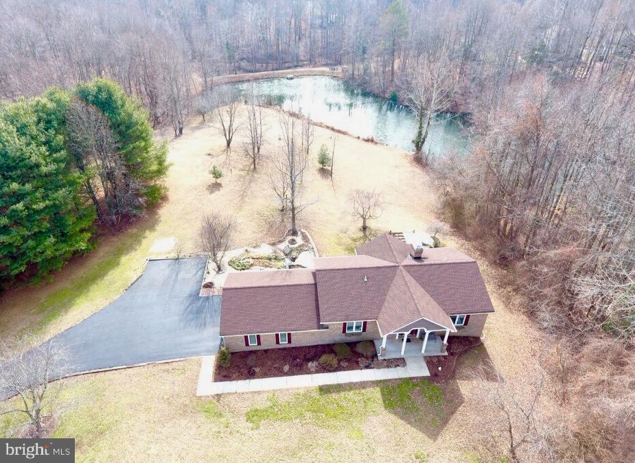 One of a Kind -Custom Built- Lakefront Privacy on 2.5 acres! Unique floor plan, soaring two story family room w/ masonry fireplace. Beautiful hardwood floors, inlays, & ceramic tile throughout. Open & airy living geared toward the serene surroundings & views. Enjoy fishing from your backyard! Well appointed kitchen w/ custom cherry cabinetry. M Bath retreat. Many more features! HSA Warranty.