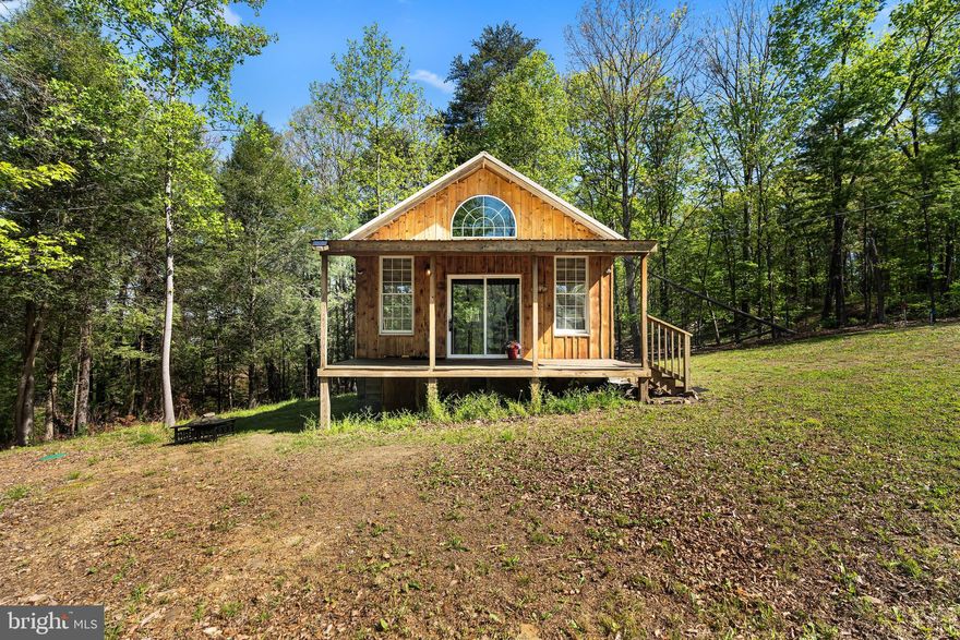 This cozy, tucked-away cabin is move-in ready with stylish finishes.  Perfect for weekend escapes or embracing tiny home living, it offers 1 bedroom, 1 bathroom, and an open floor plan linking the kitchen, dining, and living areas. A simple ladder and railing will finish off the extra loft space. The property stretches to Sleepy Creek, though the slope is steep, and being surrounded by nature makes it an ideal spot for a peaceful retreat.