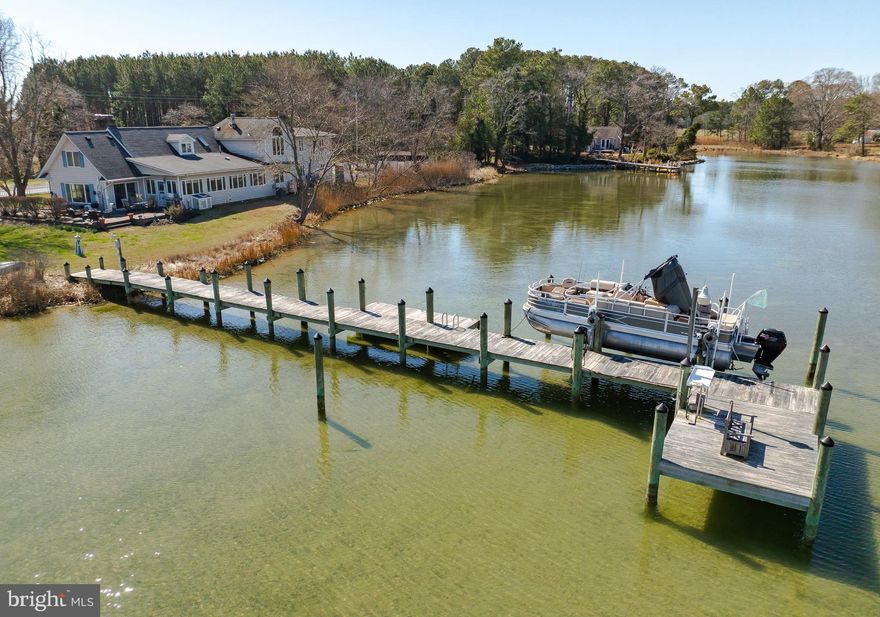 Are you finding yourself longing for a peace and quiet that only life on the water can bring?  Come home to stargazing without light pollution, dinner on the patio watching osprey, herons and geese in the creek. Spend your weekends boating, fishing, crabbing on the pier or taking long walks with both water and farm views. Invite your friends and family because this home has 6 bedrooms and 3 bathrooms with a floorplan perfect for a multi family living situation or even a vacation rental. The first floor living room is both cozy with the fireplace and also fun with the bar area and room to dance or game. You'll love the natural light coming into the kitchen with expansive windows bringing the creek views as close as you can get without stepping outside.  So much granite counter space especially with the mobile island, newer appliances, an undermount sink, appliance garage and desk space might just make this your favorite room of the house. Whether you're having elaborate formal meals or casual fare, the dining room seats as many as you want and a fireplace and amazing views to top it off.  Completing the main level are 2 spacious bedrooms, a full bath and laundry room with a 2nd shower.  You'll also appreciate the side entrance of the home that open to a large entryway currently used as a library that can double as an office with access to the 2nd level leading to another primary bedroom, ensuite bathroom with soaking tub and separate shower. Plus 3 additional bedrooms, 3rd full bath and common space where you'll discover the spiral staircase taking you back to the lower living room.  Plenty of parking with 2 paved driveways, a sideload attached garage and 2nd single car garage/shed plus another shed for storage. The covered front porch brings you panoramic views of a farm and woods where wildlife roam.  The side and backyard have unobstructed views of St. Jerome Creek where you can dock your boat or launch your kayak with easy quick access to the Chesapeake Bay.  Ridge is just far enough away from the hustle and bustle but still close enough to shopping and commuting.  Locally you'll enjoy the waterfront restaurants, farmstands and state park. Just a few minutes to historic St. Marys City and St. Marys College.
