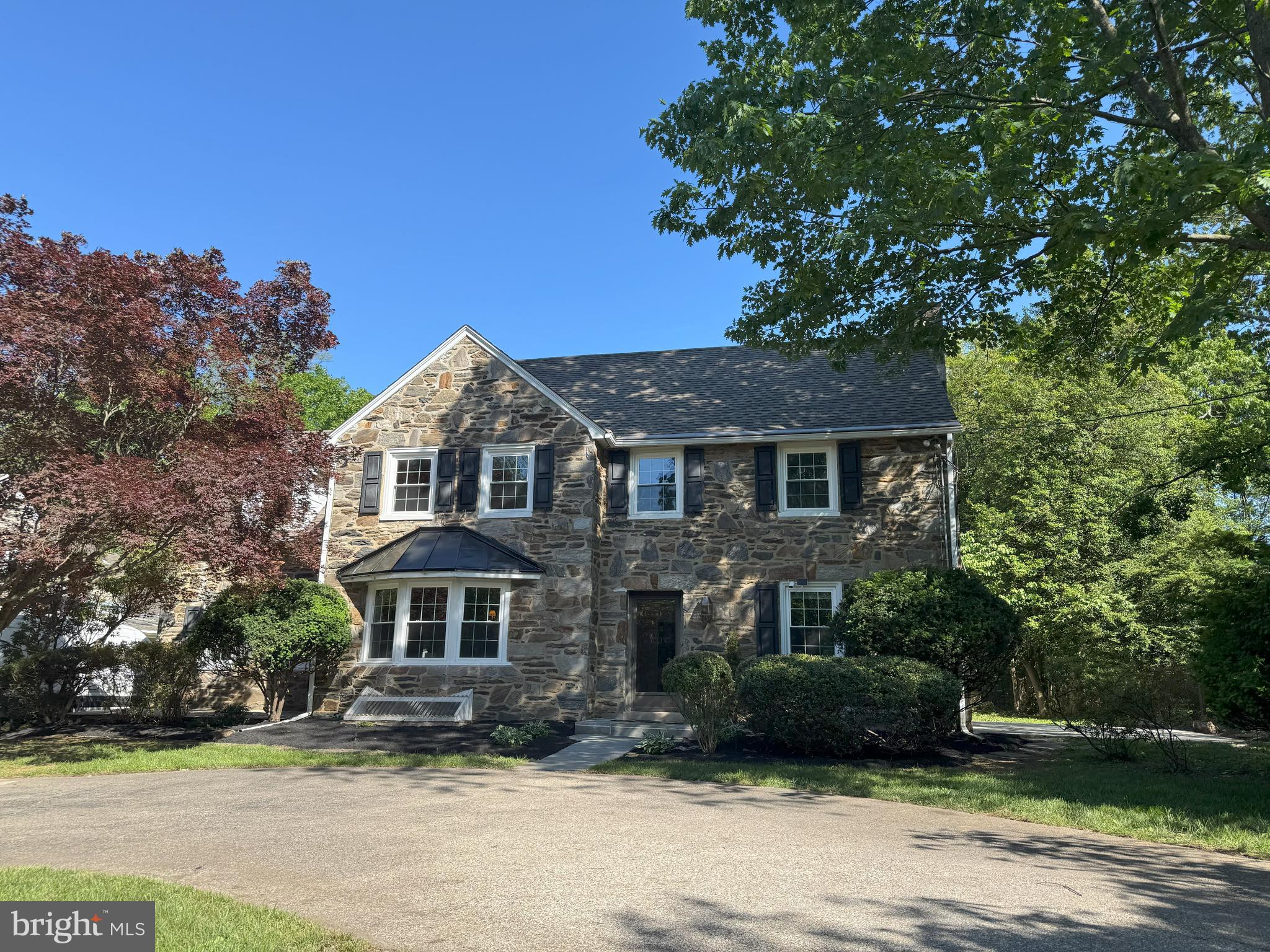 Discover the perfect blend of timeless charm and modern convenience in this classic Colonial with a large, level lot. Classic, 4 Bedroom, 2 Full Bathroom, 1 powder room, 3878 Sq Ft, Stone located walking distance to the train, Wawa, supermarket and shops in sought-after Penn Valley. This wonderful, 2-story, center hall home has a circular driveway and gorgeous hardwood floors throughout. Traditional Living Room has crown molding, chair rail, stone wood-burning fireplace, custom built-ins and French doors to a slate patio. The large formal Dining Room has crown moldings, chair rail, a large bay window with tons of light. Sizeable Family Room has wood beams and entrances from the Kitchen and Dining Room. Nice Kitchen has granite countertops, 42-inch wood cabinetry, stainless steel appliances, ceramic backsplash and an eat-in Breakfast Room. 1st Floor Powder Room. Main floor Bedroom/Office with plenty of space. The 2nd level has an oversized Master Bedroom Suite with Master Bathroom with Jacuzzi, ceramic floors, glass-enclosure shower, walk-in closet, separate Sitting Room and Laundry Room. Two additional Bedrooms with spacious closets and a brand-new full hall Bathroom. The finished Lower-Level Playroom has plenty of storage. Large front and back level yards, new wood fence, award-winning Lower Merion Schools. Walk to everything location. Schedule a private tour today and don't miss the opportunity to make this stunning property your own.