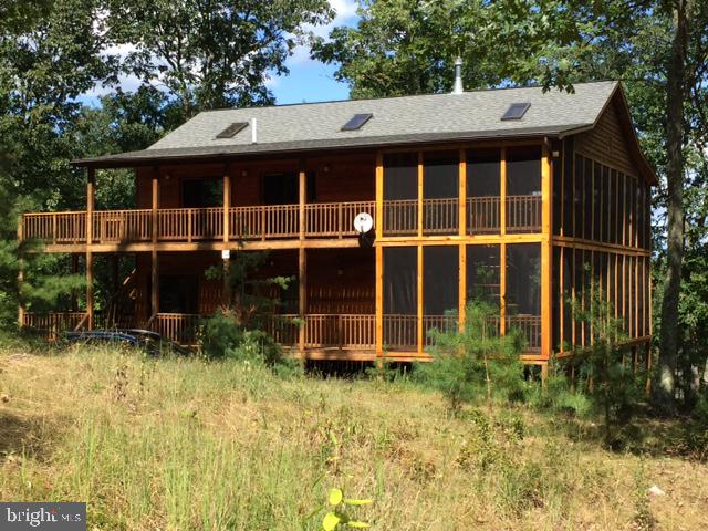 Beautiful and meticulously maintained three level cedar sided home on an established wooded lot minutes from Baker, WV. Two miles to stores, gas station, health clinic, Emergency Services, Corridor H (duel highway to East or ski area to the West). Cell service, garbage collection, maintained interior road with snow removal. 50 mig fiber optic available. Three levels, three master suites with full baths. One half bath. Wood burning fireplace in open concept living/dining/kitchen area with wood cathedral ceilings. Top of the line windows, doors.Three levels of expertly finished living space create the perfect layout for entertaining and hosting guests Two screened porches with spiral staircase connector. Covered porches, all with views. This property has a successful and lucrative Airbnb rental history with a strong following. Ask Listing Agent for details. All pertinent rental information/rental mailing lists will convey. Totally furnished house is a possibility. Will negotiated if strong offer. The house can pay for itself. This Summit is a large property in The Lost River Valley. It is known as an area of well maintained homes in a covenant protected community that has a well funded HOA.