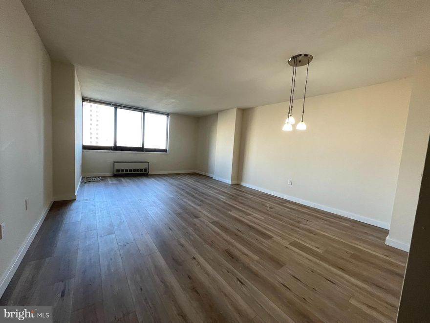 Sun-drenched one bedroom with an efficient layout and see-forever sunrise views on a high floor of Academy House. Enter through a foyer with coat closet into the combined living/dining room with space to entertain and oversized windows providing sunrise city views. The updated galley kitchen offers modern wood cabinetry, granite countertops, stainless steel appliances, and a passthrough overlooking the living area. The spacious bedroom enjoys more oversized windows, a large walk-in closet, and use of the adjacent hall bathroom with wood vanity with granite top, tub shower, and marble tile floor. There is a stacked washer/dryer in the bathroom and recently installed vinyl floors throughout. Residents of Academy House enjoy a 24-hour doorman and a state-of-the-art fitness and aquatic center. There is valet parking in the building's garage for an additional monthly fee, subject to availability. The Academy House is located in the heart of Center City and within close walking distance to Rittenhouse Square, Washington Square, and the Broad Street and Market Street office corridors. The Philadelphia International Airport and Amtrak's 30th Street Station are easily accessible.