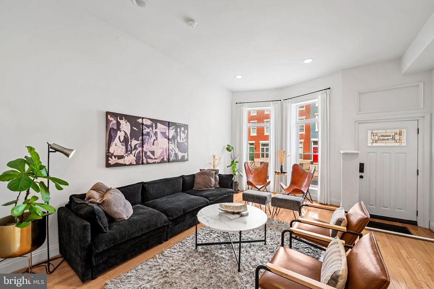 325 E 22nd Street — Historic Beauty with Modern Comfort in Old Goucher

Welcome to 325 E 22nd Street, a handsome 5-bedroom, 3.5-bath townhouse in Baltimore’s historic Old Goucher/Barclay neighborhood — surrounded by some of the city’s most celebrated restaurants and gathering spots. Clavel, WC Harlan, Fadensonnen, Sophomore Coffee, and Mama Koko’s are all just around the corner, with Penn Station nearby for easy MARC and Amtrak access to Washington, D.C., Philadelphia, and New York.

Inside, this home combines historic charm with modern functionality. The main level’s open floor plan features soaring ceilings and tall windows that fill the space with natural light. The chef’s kitchen sits at the center of it all — creating the perfect hub for everyday living and entertaining. Enjoy effortless indoor-outdoor flow with direct access to the fenced backyard, ideal for dinner parties, gardening, or relaxing with friends. A main-level laundry and powder room add convenience.

Upstairs, the second floor offers a tranquil primary suite with private en-suite bath, plus two additional bedrooms and a full hall bath. The third floor includes two large bedrooms and another full bath, providing flexible options for guests, a home office, or creative studio space.

With two-zone central A/C, updated systems, and thoughtful design throughout, comfort meets efficiency at every turn. Out back, a spacious fenced garden and two-car off-street parking pad complete this rare city package — offering true ease of living in one of Baltimore’s most walkable neighborhoods.

Steps from Station North, MICA, and Charles Village, 325 E 22nd Street is where timeless architecture, modern updates, and unbeatable location come together beautifully.