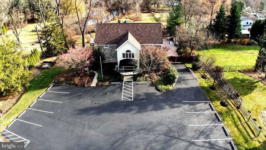 Unique mixed-use office/professional space in a prime, high-traffic location, offering both visibility and accessibility—ideal for businesses seeking exposure, with the added benefit of a private, residential, “retreat-like” setting. The 2,400 sq ft business interior features three levels, including a loft, main floor and lower level including two half baths and private office.  The 15 foot open ceilings with suspended track lighting, ceiling fans and hard wood floors on the main level create an airy, modern feel. The mezzanine loft provides additional flexible workspace including a half bathroom and storage closet.  And the lower level is spacious and provides ground level access including a half bathroom and breakroom.  The overall layout is highly adaptable, accommodating a variety of professional or mixed-use needs.  13 parking spaces.
The 2,500 sq ft residential space is on two levels, featuring two bedrooms on the main floor and a third on the ground floor.  The kitchen and dining area are adjacent, overlooking the scenic back yard.  The living room is central to the main floor living space, providing a generous gathering area.  The main floor also includes 1.5 baths and laundry area.  The lower-level living space offers a third bedroom/office/game room and foyer area.  The convenience of a 2-car attached garage with added storage area is a bonus to this residential area.
Outdoor amenities on the 1.3 acres include an in-ground, heated pool, and a charming courtyard area with outdoor firepit, perfect for entertaining, team gatherings, or client events. An automatic gate enhances privacy and security, leading to the residence area while the contrast between the busy street frontage and the tranquil rear views offers a rare balance of energy and escape.
Zoned R-1 with a D-3 variance allowing professional use.  This zoning allows for various options:  100% residence or the current mixed-use of residence and office/professional.  
Join us during our open houses on the following days:  Jan. 6th from 2-4PM; Jan. 19th from 12-2PM; Jan 27th from 11AM – 1PM and Feb. 3rd from 3-5PM.  This property is selling at public auction on February 12, 2026 at 4PM.