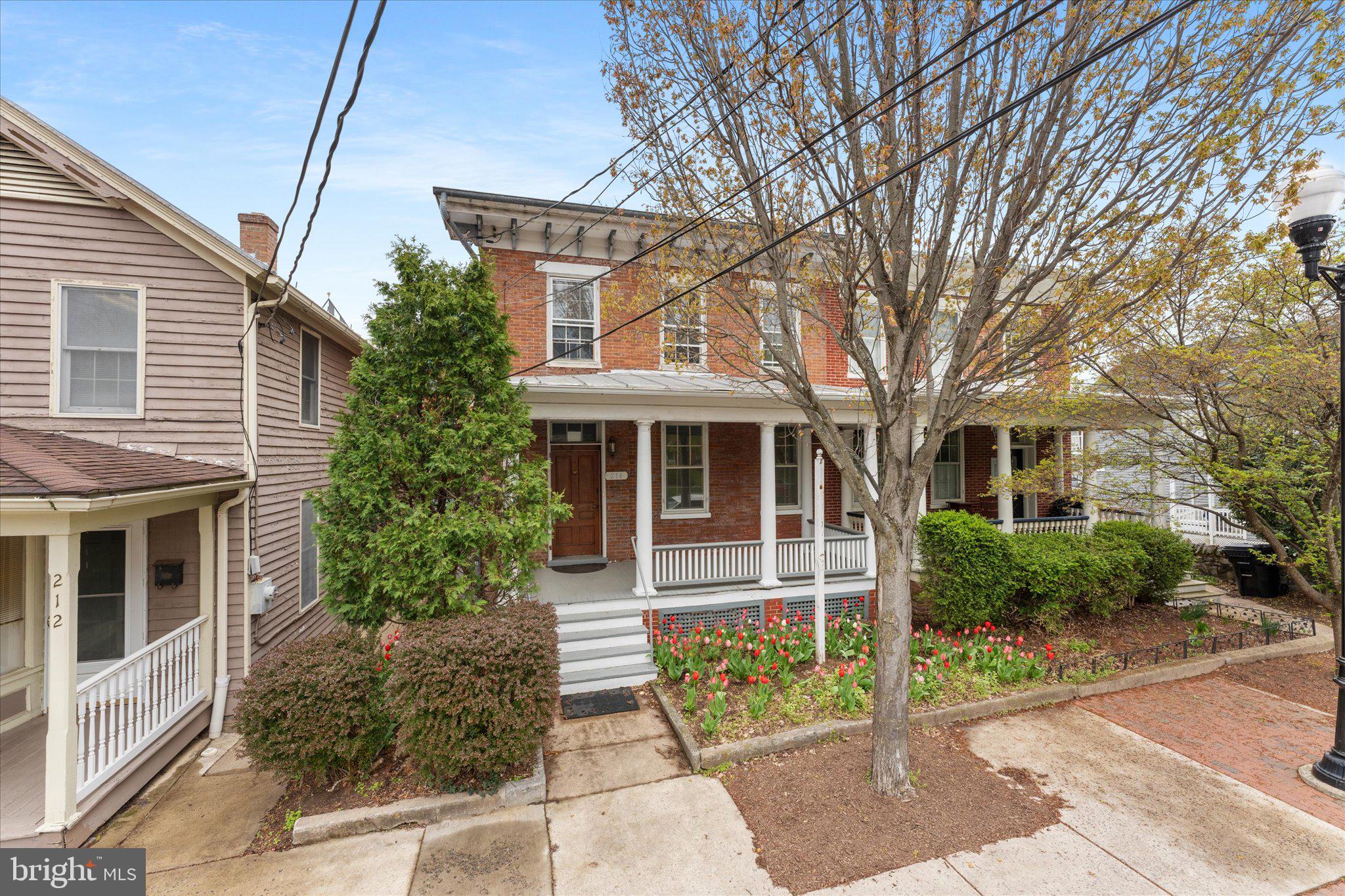 This property is currently zoned as fully commercial but has the potential to be changed to: Mixed Use or Fully Residential with proper city approval. Additional information from city located in documents. This home will need a Kitchen.
Situated in Downtown Winchester, 214 S Braddock is waiting for your ideas! Built in 1865, this home features historic charm including exposed brick walls, beautiful hardwood floors, crown molding, original fireplaces, and super high ceilings, this space is sure to impress! This home is a lot larger than it appears from the outside! Large front porch leads to a space that would be ideal for a enjoying your coffee in the morning or relaxing after a long day!
The first floor features 3 open/flex spaces plus a room with a wet bar that could be used as a breakroom and a full bathroom. Upstairs there are an additional two spaces with great natural light, a full bathroom, and an additional LARGE room that has an adjoining room for even more possibilities.
The basement has a ton of storage options and also a door that leads to the parking lot with 5 coveted spaces reserved for tenants and their clients.
Some updates have been made, but the owner will consider some upgrade requests.