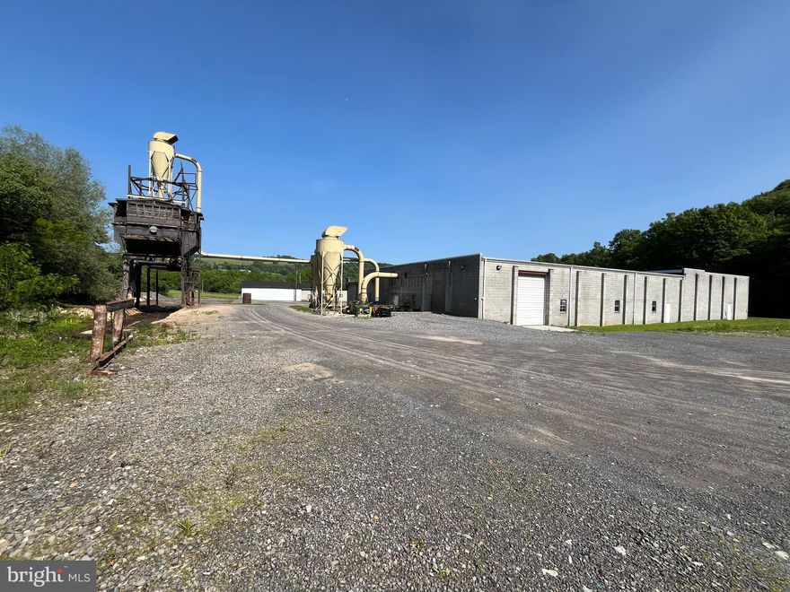 Light industrial building located just outside of Frostburg.   The main building contains 21,775 square feet with 1000 sf being office space.  This building has two large rooms with high ceilings and access to the loading dock.  There are three overhead doors for access.  The second building is a 4,800 square foot garage.  The site size is to be determined by a survey that is being completed.