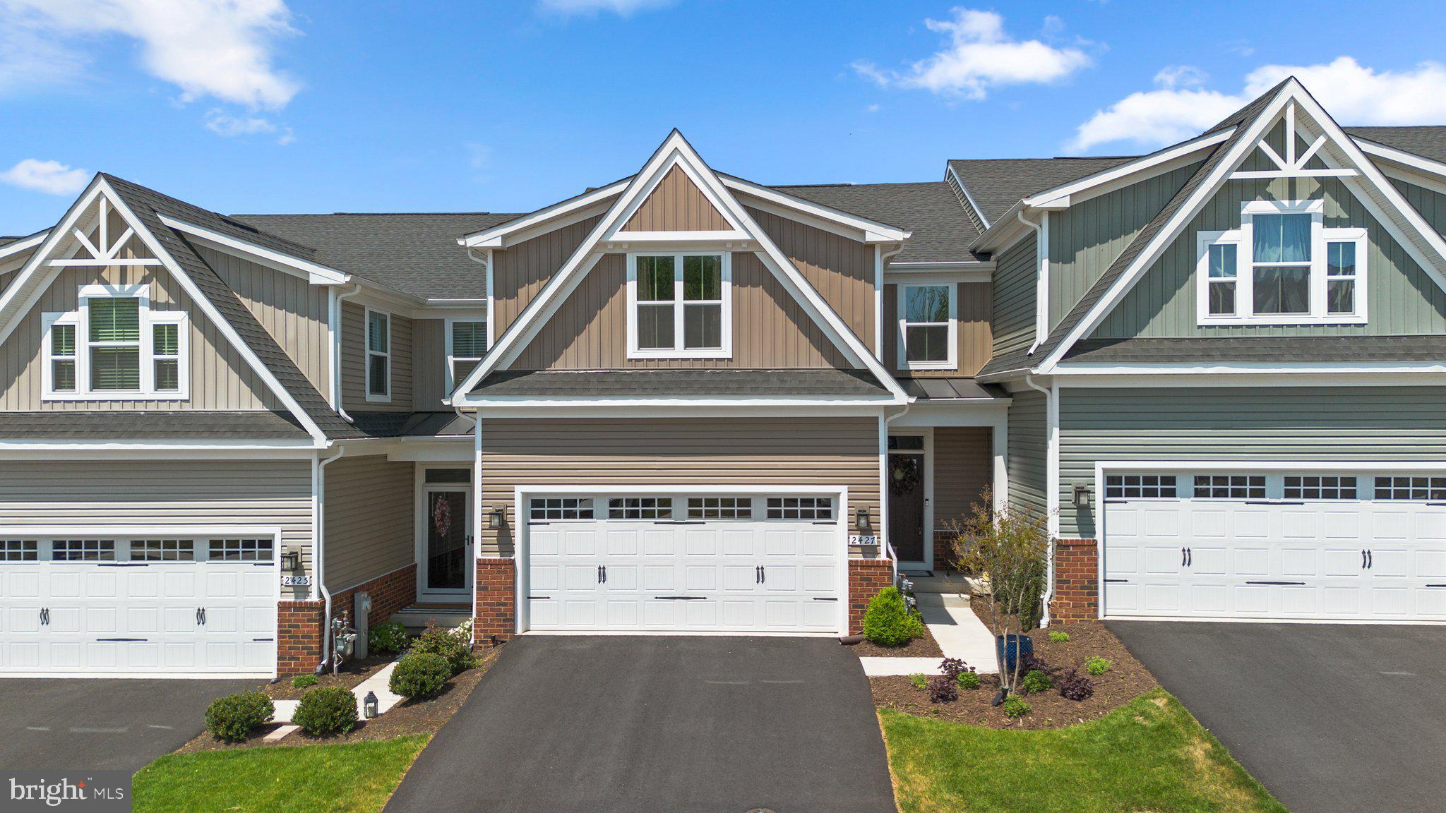 Step into this stunning 3-bedroom townhome designed for modern living and effortless style. The main level features an open-concept layout with luxury vinyl plank flooring and new hardwood stairs, showcasing a gorgeous white kitchen with a large island, stainless steel appliances including a gas range, and upgraded lighting both above the island and atop the cabinetry. The adjacent family room opens to a deckâperfect for relaxing or entertaining.
The main-level owner's suite is a true retreat, complete with a tray ceiling, an oversized walk-in closet, and a luxurious en-suite bathroom with a double sink vanity. You'll also find a convenient half bath and laundry nook on this level.
Upstairs offers two spacious bedrooms, a full hall bath, and a delightful home office/den. The fully finished lower level adds incredible versatility with a full bath and a large open space ideal for a second family room, media room, or home gym, with sliding doors that lead to a stamped concrete patio.
Additional highlights include a 2-car garage with an EV charging port. This home offers the perfect blend of comfort, convenience, and contemporary design.