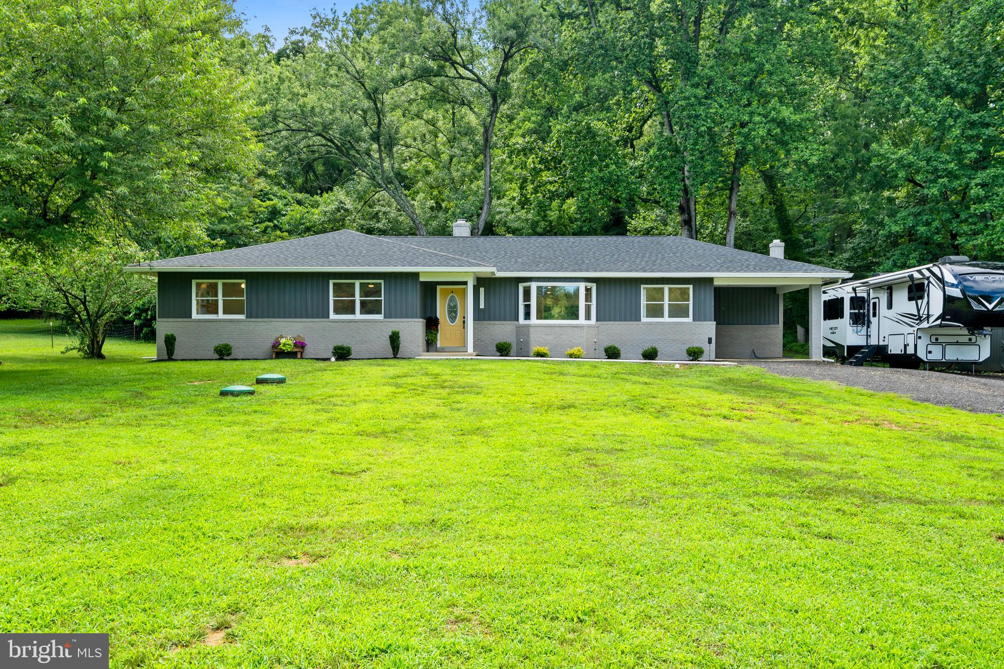 Modern Farmhouse Vibes on 4+ Private Acres in Hollywood
Welcome to your dream escape — a gorgeously renovated 3-bedroom, 2-bath rambler nestled on 4.02 picturesque acres in the heart of Hollywood, MD. From the moment you pull up, the sunny yellow door, charming “Come In” welcome mat, and modern exterior set the tone for a home that’s warm, stylish, and totally irresistible.
Step inside to a light-filled, open-concept layout where luxury vinyl plank flooring flows throughout the main living spaces. The cozy fireplace with whitewashed brick and rich wood mantel anchors the living room, while recessed lighting and fresh neutral tones create an inviting canvas for any design style.
Off the main living area, you’ll find a bright and versatile office space — perfect for working from home, tackling creative projects, or even a peaceful reading nook with a view of the lush landscape.
The chef-inspired kitchen is a total showstopper — bright white cabinets with brass hardware, open wood shelving, gleaming quartz countertops, and a bold turquoise island made for entertaining. Stainless steel appliances and gold-accented fixtures complete the upscale look.
Just beyond the kitchen, a spacious walk-in pantry with wood countertops and custom open shelving keeps everything organized in style. Down the hall, the owner’s suite offers plush carpet, serene treetop views, and a spa-worthy bathroom featuring a double vanity, matte black fixtures, and a glass walk-in shower with marble-inspired tile and river rock flooring. Two additional large bedrooms are serviced by a well appointed hall bathroom.
But the magic doesn’t stop indoors. This property is a rare blend of open space and wooded serenity. A private trail meanders through mature trees, perfect for quiet walks, adventures with pets, or sipping coffee surrounded by nature. The flat, open acreage offers endless possibilities — gardening, homesteading, or simply soaking in the peace and quiet of country living.
Whether you're entertaining under the stars or cozying up by the fire, this home strikes the perfect balance of charm, comfort, and elegance.
Schedule your private showing today and experience the beauty of Hollywood living firsthand.