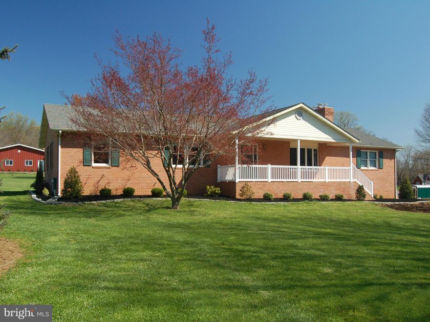 Impeccably maintained 5 BR brick rancher on over 5 acres. Long drive meanders back to quiet setting with views overlooking fields and woodlands. Spacious kitchen with lots of sunlight, cabinets and table space. Composite deck looks over lush, level yard. Large 3 car garage with heat and plumbing.  Additional barn or storage building.  Adjoining 5 acre building lot available.