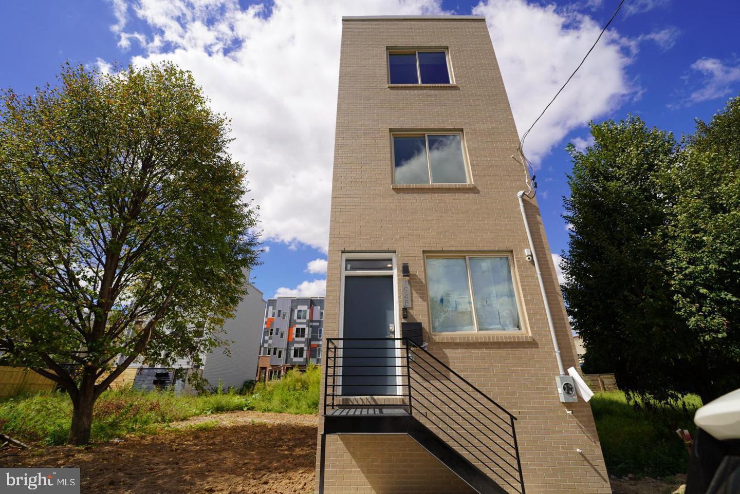 Beautifully designed 3-story home featuring 3 bedrooms and 3 full bathrooms, located in the heart of Norris Square. Step into an open-concept living and dining area accented by a modern built-in electric fireplace and a striking granite brick accent wall with matching mantle. The kitchen boasts white shaker cabinets with elegant gold hardware, an island with pendant lighting and seating for two, and a full stainless steel appliance package. Through the rear door, enjoy access to a private backyard—perfect for outdoor relaxation or entertaining.
The fully finished basement includes a full bathroom with a walk-in shower and a single storage vanity, making it an ideal space for a home office, den, or additional bedroom.
On the second floor, you’ll find two spacious bedrooms, a stacked washer and dryer closet, and a shared hall bath featuring a gray single vanity and a tub/shower combo. The third-floor primary suite offers two generous closets, a frameless walk-in shower, a dual white vanity with ample storage, and a large linen closet.
Just outside the primary suite, you'll find a convenient wet bar with a mini fridge, perfectly positioned for easy access to the rooftop deck—ideal for entertaining or relaxing with sunset views.
Located just a short walk from Riverwards Produce Market and the vibrant dining scenes along 2nd Street, Front Street, and Frankford Avenue. Easy access to public transportation via the Market-Frankford Line.
