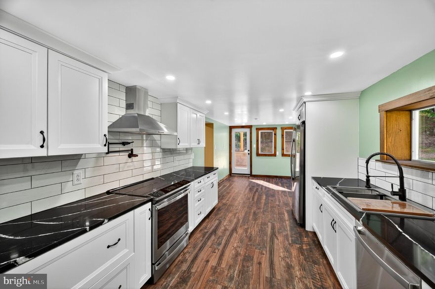 NEW PRICE, SAME AMAZING PROPERTY! A Rare Blend of History and Modern Luxury — on 36.8 Acres!

Once known locally as “The Pioneer,” this unique property was originally built in 1949 by the Wagoner family as a restaurant and general store, serving neighbors and travelers with hearty meals, fishing bait, snacks, and even 50–100 lb ice blocks before electricity reached the area. The southern boundary of the land still marks the line between Hampshire and Mineral County, while stories of its past linger in the landscape.

Today, that history has been beautifully preserved while the home itself has been completely reimagined. Taken down to its framing and rebuilt with all new electrical, plumbing, and three separate HVAC systems (two electric, one propane), it offers true modern efficiency wrapped in historic character. With full R-19 & R-30 insulation in walls, ceilings, and floors, plus a propane system so efficient one full tank can heat the home for up to two years at 72°, comfort comes standard. High-speed internet is coming soon with new lines installed along the road in 2024.

Inside, the home lives like brand-new construction — never before occupied since its complete renovation. The layout features 3 bedrooms, 3 bathrooms, a cozy fireplace, and a state-of-the-art kitchen with all-new appliances. A spacious laundry room (with new washer and dryer included) can easily be repurposed into a fourth bedroom, office, or bonus space, with laundry relocated to the basement if desired.

The land itself is just as impressive — 36.8 acres across three parcels (8.5, 4.49, and 23.8 acres) with a network of wide trails and roads perfect for exploring on foot or by vehicle. Towering hardwoods with high canopies create a peaceful, park-like setting, with soft moss and open forest floors that invite exploration.

Additional highlights include a charming oak-built barn in excellent condition, a large flat area for gatherings or animals, and a regraded rear property for improved watershed, added parking, and stair-free access to the upper level of the home.

Whether you’re drawn to its history, captivated by its craftsmanship, or inspired by the endless opportunities on nearly 37 acres, this property offers a rare chance to own a true one-of-a-kind estate where timeless charm meets modern living.