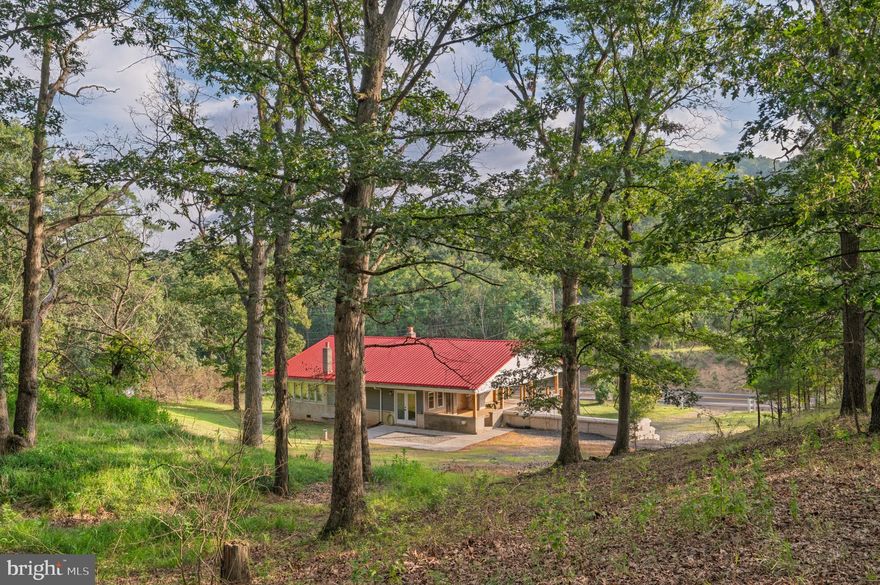 NEW PRICE, SAME AMAZING PROPERTY! A Rare Blend of History and Modern Luxury — on 36.8 Acres!

Once known locally as “The Pioneer,” this unique property was originally built in 1949 by the Wagoner family as a restaurant and general store, serving neighbors and travelers with hearty meals, fishing bait, snacks, and even 50–100 lb ice blocks before electricity reached the area. The southern boundary of the land still marks the line between Hampshire and Mineral County, while stories of its past linger in the landscape.

Today, that history has been beautifully preserved while the home itself has been completely reimagined. Taken down to its framing and rebuilt with all new electrical, plumbing, and three separate HVAC systems (two electric, one propane), it offers true modern efficiency wrapped in historic character. With full R-19 & R-30 insulation in walls, ceilings, and floors, plus a propane system so efficient one full tank can heat the home for up to two years at 72°, comfort comes standard. High-speed internet is coming soon with new lines installed along the road in 2024.

Inside, the home lives like brand-new construction — never before occupied since its complete renovation. The layout features 3 bedrooms, 3 bathrooms, a cozy fireplace, and a state-of-the-art kitchen with all-new appliances. A spacious laundry room (with new washer and dryer included) can easily be repurposed into a fourth bedroom, office, or bonus space, with laundry relocated to the basement if desired.

The land itself is just as impressive — 36.8 acres across three parcels (8.5, 4.49, and 23.8 acres) with a network of wide trails and roads perfect for exploring on foot or by vehicle. Towering hardwoods with high canopies create a peaceful, park-like setting, with soft moss and open forest floors that invite exploration.

Additional highlights include a charming oak-built barn in excellent condition, a large flat area for gatherings or animals, and a regraded rear property for improved watershed, added parking, and stair-free access to the upper level of the home.

Whether you’re drawn to its history, captivated by its craftsmanship, or inspired by the endless opportunities on nearly 37 acres, this property offers a rare chance to own a true one-of-a-kind estate where timeless charm meets modern living.