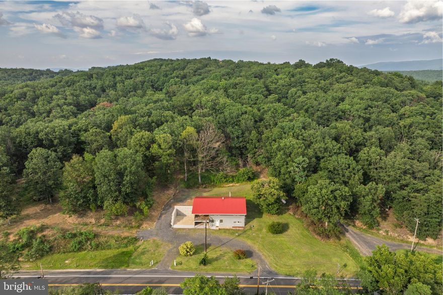 NEW PRICE, SAME AMAZING PROPERTY! A Rare Blend of History and Modern Luxury — on 36.8 Acres!

Once known locally as “The Pioneer,” this unique property was originally built in 1949 by the Wagoner family as a restaurant and general store, serving neighbors and travelers with hearty meals, fishing bait, snacks, and even 50–100 lb ice blocks before electricity reached the area. The southern boundary of the land still marks the line between Hampshire and Mineral County, while stories of its past linger in the landscape.

Today, that history has been beautifully preserved while the home itself has been completely reimagined. Taken down to its framing and rebuilt with all new electrical, plumbing, and three separate HVAC systems (two electric, one propane), it offers true modern efficiency wrapped in historic character. With full R-19 & R-30 insulation in walls, ceilings, and floors, plus a propane system so efficient one full tank can heat the home for up to two years at 72°, comfort comes standard. High-speed internet is coming soon with new lines installed along the road in 2024.

Inside, the home lives like brand-new construction — never before occupied since its complete renovation. The layout features 3 bedrooms, 3 bathrooms, a cozy fireplace, and a state-of-the-art kitchen with all-new appliances. A spacious laundry room (with new washer and dryer included) can easily be repurposed into a fourth bedroom, office, or bonus space, with laundry relocated to the basement if desired.

The land itself is just as impressive — 36.8 acres across three parcels (8.5, 4.49, and 23.8 acres) with a network of wide trails and roads perfect for exploring on foot or by vehicle. Towering hardwoods with high canopies create a peaceful, park-like setting, with soft moss and open forest floors that invite exploration.

Additional highlights include a charming oak-built barn in excellent condition, a large flat area for gatherings or animals, and a regraded rear property for improved watershed, added parking, and stair-free access to the upper level of the home.

Whether you’re drawn to its history, captivated by its craftsmanship, or inspired by the endless opportunities on nearly 37 acres, this property offers a rare chance to own a true one-of-a-kind estate where timeless charm meets modern living.