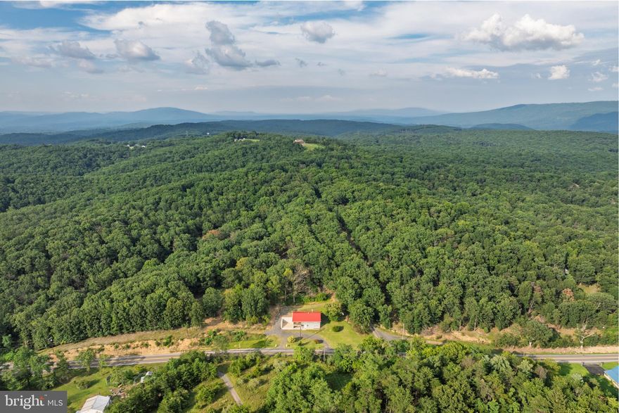 NEW PRICE, SAME AMAZING PROPERTY! A Rare Blend of History and Modern Luxury — on 36.8 Acres!

Once known locally as “The Pioneer,” this unique property was originally built in 1949 by the Wagoner family as a restaurant and general store, serving neighbors and travelers with hearty meals, fishing bait, snacks, and even 50–100 lb ice blocks before electricity reached the area. The southern boundary of the land still marks the line between Hampshire and Mineral County, while stories of its past linger in the landscape.

Today, that history has been beautifully preserved while the home itself has been completely reimagined. Taken down to its framing and rebuilt with all new electrical, plumbing, and three separate HVAC systems (two electric, one propane), it offers true modern efficiency wrapped in historic character. With full R-19 & R-30 insulation in walls, ceilings, and floors, plus a propane system so efficient one full tank can heat the home for up to two years at 72°, comfort comes standard. High-speed internet is coming soon with new lines installed along the road in 2024.

Inside, the home lives like brand-new construction — never before occupied since its complete renovation. The layout features 3 bedrooms, 3 bathrooms, a cozy fireplace, and a state-of-the-art kitchen with all-new appliances. A spacious laundry room (with new washer and dryer included) can easily be repurposed into a fourth bedroom, office, or bonus space, with laundry relocated to the basement if desired.

The land itself is just as impressive — 36.8 acres across three parcels (8.5, 4.49, and 23.8 acres) with a network of wide trails and roads perfect for exploring on foot or by vehicle. Towering hardwoods with high canopies create a peaceful, park-like setting, with soft moss and open forest floors that invite exploration.

Additional highlights include a charming oak-built barn in excellent condition, a large flat area for gatherings or animals, and a regraded rear property for improved watershed, added parking, and stair-free access to the upper level of the home.

Whether you’re drawn to its history, captivated by its craftsmanship, or inspired by the endless opportunities on nearly 37 acres, this property offers a rare chance to own a true one-of-a-kind estate where timeless charm meets modern living.