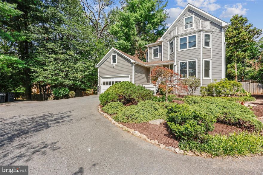 This incredible Victorian home is tucked away on a pipestem off Wilson Lane—set far from the road in a peaceful enclave. Nestled in a truly private setting with mature landscaping and ample parking, this striking contemporary residence offers over 4,500 square feet of living space, including five bedrooms and 3.5 bathrooms across three thoughtfully finished levels. Originally built in 1988, the home has been carefully updated over time, including new siding, new Trex deck, replacement windows, and a new dual-zoned HVAC system.

Defined by dramatic ceiling heights, distinctive octagonal architecture, and stunning windows, this home offers a unique and inviting character. Inside, you'll find an entry foyer, a living room with crown molding, a large dining room with a China closet, a spacious kitchen with breakfast area, and a dramatic two-story family room. The sunlit kitchen features GE double wall ovens, solid surface countertops, recessed lighting, a GE Profile five-burner gas cooktop, a pantry, a built-in desk, and a fabulous octagon-shaped breakfast room with access to the Trex deck. The showstopping family room includes a soaring Palladian window, French doors to the deck, a marble wood-burning fireplace, and a built-in wet bar with glass display shelving. A powder room and coat closet complete the main level.

Upstairs, the luxurious primary suite includes multiple closets with organizers—including two walk-ins—cathedral ceilings, a ceiling fan, and access to a spacious private loft. This versatile upper-level loft / retreat offers an office area with a balcony, fitness space, and a cedar walk-in closet. The primary bathroom includes a double vanity, a jetted soaking tub, and a separate shower. Two additional bedrooms, each generous in size and able to comfortably accommodate two beds, a hall bathroom, and a laundry closet complete the upper level.

The walk-out lower level features a large recreation room with a fireplace and wet bar, two more bedrooms, a full bathroom, and a sizable storage room.

Sitting on an extraordinary 22,559 square foot lot, the home’s outdoor space includes a fenced backyard, a new Trex deck with cabled railing, a brick paver patio, a shed, a two-car garage, and additional surface parking. The home’s architectural style beautifully integrates with the natural surroundings, creating a tranquil retreat with easy access to everything Bethesda has to offer. Just steps from Pyle Middle School and Whitman High School, and ideally located near Downtown Bethesda, local shopping, and the Capital Beltway—this is a rare opportunity not to be missed!