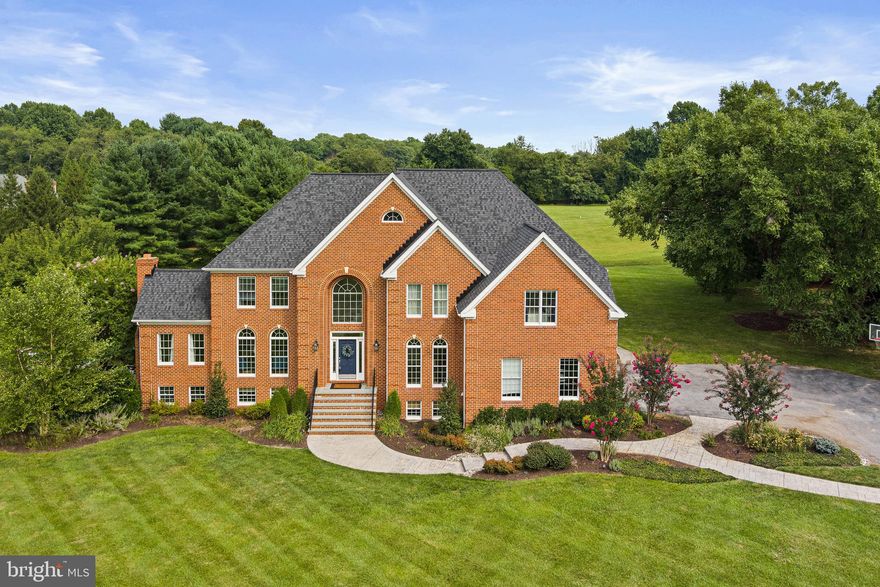 Welcome to the prestigious neighborhood of Second Discovery. This stately brick home, located on Maryvale Court, epitomizes elegant colonial architecture and is set on 3 acres of lush, open land with mature trees for added privacy. With over 6,400 finished square feet, be prepared to be amazed at every turn. This home boasts fresh custom paint in modern colors, elegant crown moldings, beautiful draperies and hardwood floors and all the distinguished features you’d expect. The large formal living room is complete with a classic brick fireplace and room for a grand piano, while the formal dining room offers a sophisticated setting for special occasions. Sunlit rooms fill the home with natural light, and the main two-story entry showcases a graceful curved staircase w/ soaring windows. The den, featuring custom built-ins, exudes classic charm. The fully updated, modern kitchen is a chef’s dream with custom cabinetry, granite counters, beautiful island, stainless appliances, and a stunning Wolfe stainless gas range. Adjacent to the kitchen, you'll find a charming eating area which flows to the family room featuring impressive cathedral ceilings and a two-story brick fireplace which adds a dramatic and cozy touch to the space. Additionally, there's a light filled double family room that can serve as a conservatory, dance area, or any other space that suits your needs. The expansive composite deck features multiple levels with pergola, and hot tub complete with pastoral views.  Accessible from both the kitchen and family room this area is perfect for outdoor relaxation and entertaining. The majestic second level features a large primary bedroom with elegant curved walls, custom paint and drapes, and lovely trim package. The adjoining  fully renovated primary bathroom boasts a double custom shower, an elegant soaking tub, double vanities, and a grand walk-in closet suite designed for maximum comfort and organization. The upper level floor plan features spacious bedrooms 2 and 3 which share a fully updated Jack and Jill bathroom, while Bedroom 4 has a dedicated full bath. Additionally, a walk-up staircase leads to a huge attic storage space. The fully finished lower level boasts soaring ceilings, lots of natural light  and a spacious family room complete with a pool table, perfect for entertaining. It includes a completely renovated full bath and  convenient second lower-level laundry room. This level also features a large, light-filled fifth bedroom. The family room offers easy access to the poolside and patio areas, where you’ll find a stunning pool with a waterfall, custom hardscaping, and beautiful plantings. Multiple seating areas around the pool make it an ideal spot for relaxation and gatherings. Glenelg Country School is conveniently located just across the street from the community entrance, offering easy access for families. Additionally, Benson Branch Park is nearby, featuring hiking trails and picturesque scenery. This neighborhood stands out as one of the most desirable and ideal settings in Howard County. Opportunities in this area don’t come along often. Make it yours!