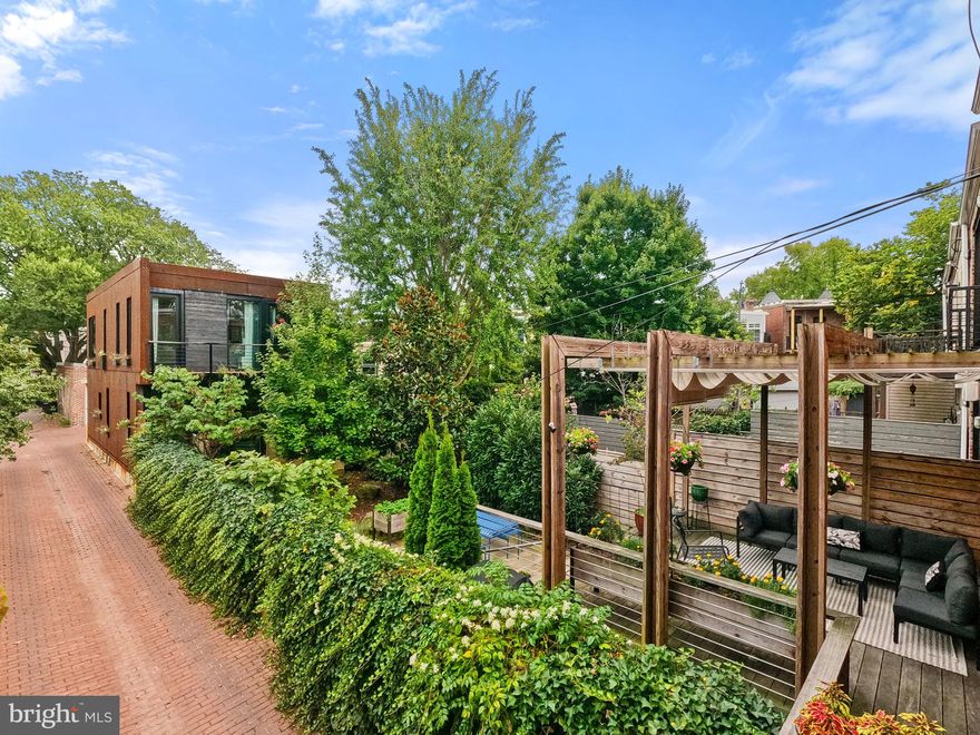 A MODERNIST MULTI-HOME MASTERPIECE - Less than a block from Lincoln Park and Maury Elementary, this rare corner-lot retreat offers modern living across two stunning residences. Inside the main floor solid maple hardwoods and streamlined custom millwork,  central living room with fireplace and floor-to-ceiling bookshelves, a sleek kitchen overlooking  Kebony deck and pergola. Upstairs, FOUR bedrooms include a serene primary suite with wall-to-wall cabinet closets and a glass-wrapped bath. The finished lower level adds flexible guest space with its own bath and private exit.   Head through the lush garden to step through a sliding wall of glass to the new steel-clad carriage house (2023), featuring spacious living/dining/kitchen zone with soaring ceilings, 2 upper sunlit bedrooms plus office, 2.5 baths, plus garage with EV charging, and substantial storage closets to maximize every square foot.

Call for a private tour TODAY!