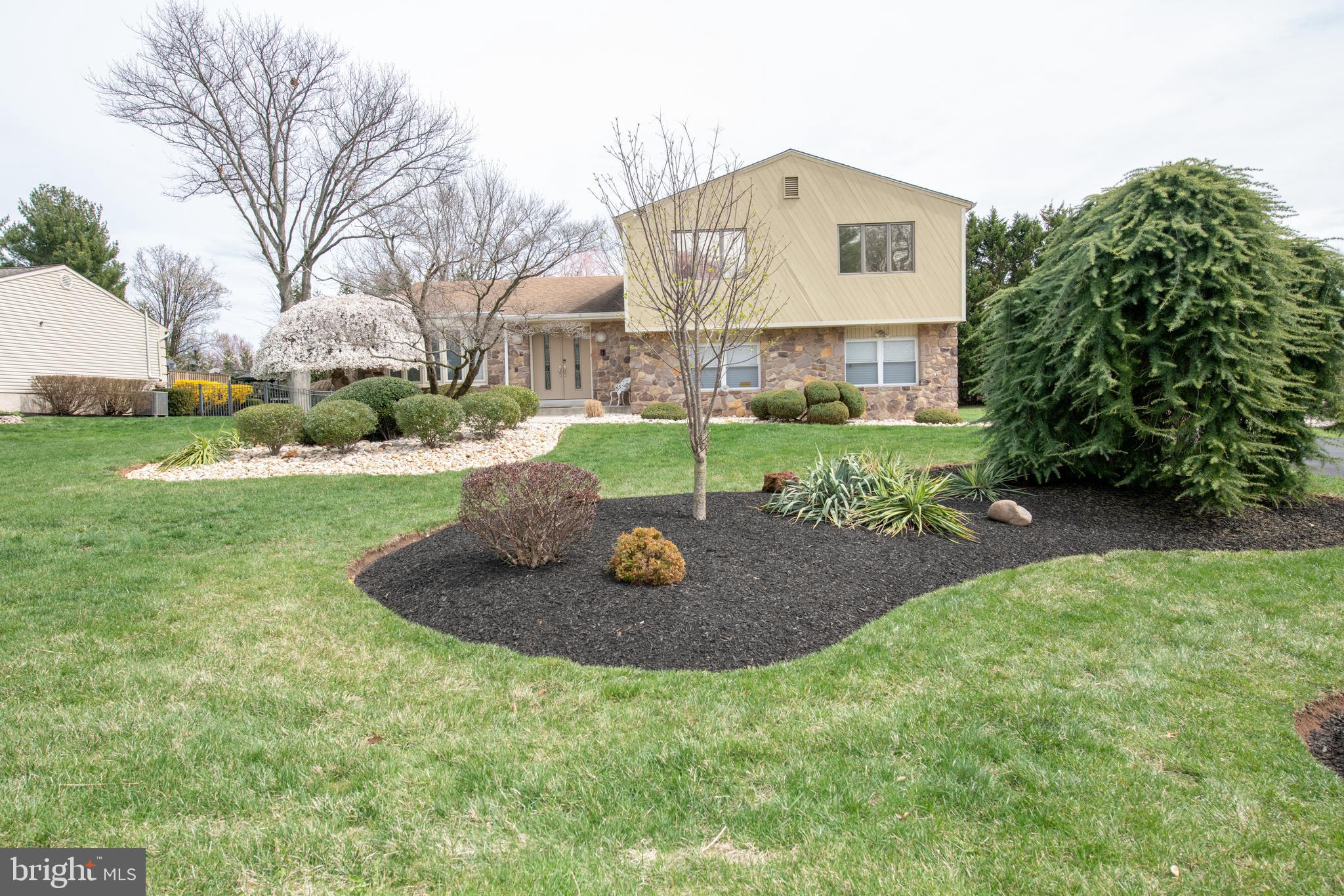 You won't be disappointed with this beautiful, spacious, updated and immaculately kept 3 bedroom, 2 & 1/2 bath split level home in the desirable Deerfield North neighborhood and in the highly rated Council Rock school district. (A first floor bonus room can be converted to fourth bedroom If desired) This stone and siding home has stunning curb appeal with gorgeous, professionally landscaped grounds. Enter via the concrete walkway and the covered front entrance into a grand foyer with vaulted ceiling, mirrored double door coat closet and modern luxury vinyl tile floors. To your left is the bright, sunny formal living room with a huge bay window overlooking the beautiful grounds. A step up to the spacious formal dining room with large casement windows, a perfect place to host your holiday dinners. The remodeled eat-in kitchen features custom cabinets to the ceiling, pantry cabinet with pull-out drawers, granite counter tops, tile backsplash, stainless steel appliances, custom range hood, vaulted ceiling, recessed lights, ceiling fan and eat-in area with sliding glass doors to a large deck which makes it so convenient for your barbecues. The family room has a huge bay window with a motorized shade, wood burning fireplace with glass enclosure and stone surround. There is a door to a lovely covered patio with ceiling fan where you can relax with a cup of coffee or glass of wine while enjoying your tranquil backyard. A convenient powder room with pedestal sink and a large bonus/laundry room with cabinets and folding counter complete the first floor. Second floor: huge primary bedroom that was 2 bedrooms made into a large suite with double walk-in closets, ceiling fan and attached primary bath with linen closet, large steam shower , heat lamps and double sink vanity. The 2 additional good-sized bedrooms have large cosets, recessed lights and ceiling fan. The hall bath has a double sink vanity and tub/shower with glass doors. A hall linen closet completes the second floor. Additional features: upgraded, luxury vinyl tile in most of the first floor; finished basement with built-in wall unit and storage room with shelving; new heating and AC (2024); all windows and doors have been replaced; one car side garage with electric opener and inside access; security system, backyard shed and so much more!!! Make your appointment today!!