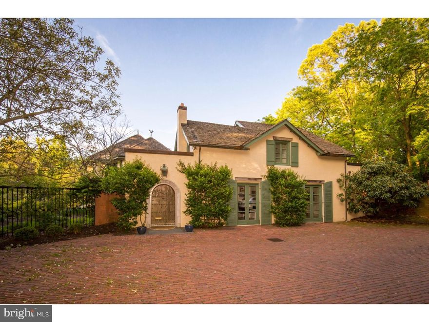 This gorgeous French Provincial estate is situated on a spectacular hillside in lovely Wyndmoor. Just beyond the front courtyard sits a rare 3 bedroom , 4-1/2 bath treasure. Enter through the arched door way into the bright and spacious foyer to find unique details such as antique French fireplaces, ornate mill work, wide plank floors, exposed wood beam ceilings, and stone and tile through out. On the main level there is a quiet library with a fireplace, formal dining room and great room featuring marble floors, fire place, and french doors leading to terrace. The open kitchen flows into the family room which fills with light from all directions. The focal point of this comfortable living space is a stone carved hearth that defines the elegance of this home.  The main stair leads to the exquisite master bedroom suite, which features two separate bath areas, walk-in closets, balconies, and laundry. A second stair leads to two additional spacious bedrooms; each with an en suite bath. Too many improvements to list, including a fourth en suite bedroom, den or yoga room located just off the living room on the ground level . This additional space was created by installing a European style double casement window which looks out on a beautiful natural field. The exterior of the home is the perfect setting for entertaining or a private retreat as you overlook the stunning tiered garden, fountains, pool, mature plantings and breathtaking valley views. Fabulous detached art studio with heated floors invites the outside in and can be used in a variety of creative ways. The serene country location also offers easy access to center city and the village of Chestnut Hill.