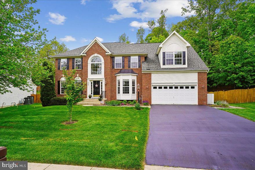 Pride of ownership shows throughout this beautifully maintained 3 level brick front and brick rear colonial home on a premium 17,402 sq ft lot  featuring 5 bedrooms and 3.5 baths. Spacious open floor plan with almost 4,000 sq ft finished on upper level  and 1,926 sq ft ready for completion. 
Welcome!  Your tour begins with a 2 story foyer with stairs to the kitchen and opening to living room and library/office  with custom built-in bookcases and bay window. Adjoining the living room  is a large formal dining room with full bay window viewing private fenced backyard. The heart of the home - a gourmet kitchen features upgrade cabinets, granite countertops, high bar seating, an island perfect for meal prep, gas cooktop cooking and extra seating. The kitchen opens seamlessly to large a sunroom/breakfast room  filled with windows, vaulted ceiling, and  French Doors open to beautifully landscaped yard featuring a stamped concret patio with pergola and stone knee wall. Patio features a Sun-Setter Awning with light bars and drop-down sun screen ideal for entertaining or enjoying the serenity of nature and peaceful sound of a water feature. 
 A bright, spacious family room features 4' extension, lots of windows, a gas fireplace opens to the kitchen and sunroom creating the perfect spot for gatherings.
Upper level highlights: Luxurious primary suite with 4' extension, double walk-in his and her partition closet, private bath with walk-in shower, designer tile, double vanities, sitting area, gable window with built in bench, high cathredral ceiling, 4 additional bedrooms and 2 addtional baths ( hall bath and Jack and Jill bath between bedrooms 3 & 4), 5th bedroom is being used as an exercise room for upper level convenience and an upper level laundry area 
Lower level features area features 4' extension, rough-in for full bath, windows and French Doors open to walk-up  exterior stairs. 
A list of more upgrades and additions can be found in BRIGHT agent documents.
One year HSA Buyer Warranty  Conveys at settlement.
Great location convenient to schools, commuter access, military bases, shopping and more!