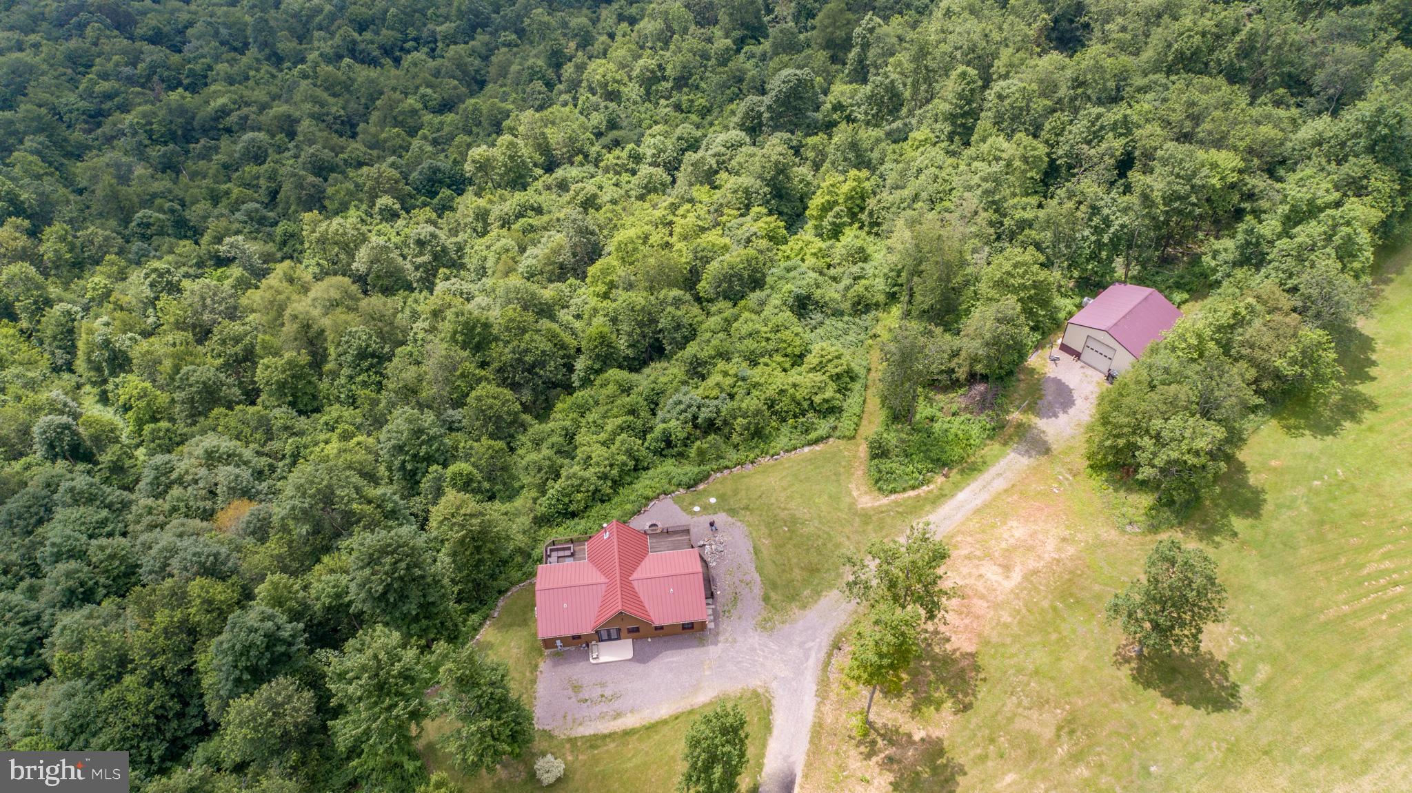 Sitting atop Keyser’s Ridge, there is a white-pine, log cabin home on 12.86 acres, with breathtaking panoramic Appalachian Mountain views, available to become your new home. The French entry doors lead you into the modern, rustic kitchen with Alder wood, and soft-close cabinetry. Cascading light from the floor to cathedral ceiling windows in the great room draws you in, where you access the over sized deck. Not only is there plenty of sitting room for all of your friends and family, but there is a sliding patio door leading to the primary suite and one of the other bedrooms as well. Going through that bedroom, you find a bathroom with a combo shower/tub and one more of the bedrooms. Returning to the great room from that hallway, the sunshine is highlighting a brick red wood-burning stove in the corner across the room, next to the windows. The lower level has the other two bedrooms, a full bathroom, a living room, complete kitchen with modern appliances and plenty of room for a dining table. There is a large walk-in pantry that could also be used as a laundry room. The Harman pellet stove is great for heating the basement, but keeps the natural pine hardwood floors throughout the main level warm for those many yo-yo temperature months, saving money. The living room has sliding patio doors, leading to the covered concrete patio. One end of the patio is wired and ready for hot tub placement, the fire pit is mortared and ready for hot dogs and marshmallows, and the grill is ready, just plug in your tank and fire it up. The land is versatile and follows the Forest Stewardship Plan. There are paths to walk, or ride ATVs, and you will even find a small pond. There is a 30x36 pole barn with electricity, for you to store your boat, along with all your summer and winter toys, and a three acre </> field adjacent to this building. It is kept manicured and ready for any activity or event you need; a yard sale, football game, birthday party, multiple summer games all at once, you name it.
Some bonus points are:
Whole-house water filtration system added in 2023
Entire house and deck stripped and restained in 2023, stained again in 2024 – good for 5-7 years now
Split unit installed in the living room in 2023 – provides heat and air conditioning
New microwave in 2024 that is also an air fryer, broiler, grill, oven, steamer. and more
This property is part of the Forestry Stewardship Plan, established in 2024, and the plan will transfer to the new owner.
Patio is already wired for a hot tub.
**I-68 IS AT THE END OF DEVILS HALF ACRE RD – AMAZINGLY CONVENIENT
**30-40 MINUTES TO MORGANTOWN, WV
**LESS THAN 1.5 HOURS FROM PITTSBURGH, PA
**LESS THAN 2.5 HOURS TO BALTIMORE, MD