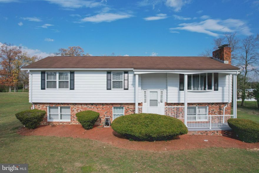 This timeless 4BR/ 2BA 2,300 square feet split foyer is a must see classic on over an acre! Tucked away in South Berkeley County, 445 Shickle Lane is an immaculately kept, one owner home now available to be called yours!  The top level includes a large eat in kitchen with the classic "must have" features like a window over the sink in the kitchen and built-in cabinets in the dining room for additional storage. The kitchen also has a breakfast bar and pantry with a sliding glass door to an amazing deck. The living room is bright with a beautiful bay window and feature wall with a pleasing brick wood burning fireplace and mantel. Down the hall, you will find 3 bedrooms with a full bathroom in the hallway. Full bath includes shower/ tub combo  Carpeted rooms feature new carpet with fresh paint throughout.  
The downstairs in this lovely split foyer has a host of opportunities and was most recently used as an extended family suite featuring its own living room and woodstove, multiple rooms and a large utility room with a washer and dryer to convey.   The downstairs is a walk out with its own separate entrance giving way for many useful possibilities.  Every detail of this home has been preserved with care.  New features include new water heater, new Central Air unit, baseboard heat with updated thermostats and roof updated within 3 years. 
The outside space is a versatile flat parcel.  The yard has a grove of fruit trees including varieties of peach, pear and apple. The landscaping is mature, and you can enjoy it all from your high view on the two story double deck/ patio combo.  This Spring will be a magical explosion of irises and other perennials.  You can  add a pool easily with outdoor electric available.  The outdoor building is 16x12 and a perfect workshop and storage.  There is so much to love about the opportunity presented with this home!  With room to roam both inside and out, book your showing today!