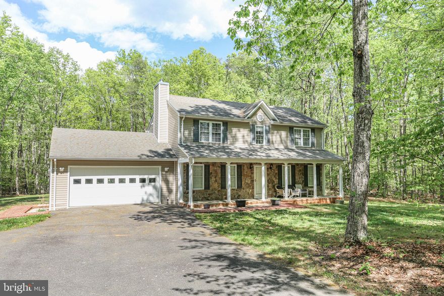 Discover the charm of this stunning Colonial-style home, nestled on a generous 5.07-acre lot that backs to serene trees, offering a perfect blend of privacy and natural beauty. Built in 2004, this detached residence features four spacious bedrooms and two and a half bathrooms, providing ample space for relaxation and comfort. Step inside to find a warm and inviting atmosphere, enhanced by modern conveniences. The heart of the home boasts a well-appointed kitchen equipped with essential appliances, including a built-in microwave, dishwasher, refrigerator, stove, washer, and dryer, making daily tasks a breeze. The property includes both an attached and a detached garage, providing plenty of space for vehicles and storage. The oversized garage features a front entry and convenient inside access, ensuring ease of use. Outside, the expansive lot invites you to explore endless possibilities—Imagine creating your own outdoor oasis or simply enjoying the tranquility of nature right in your backyard, with Lake Anna just 10–15 minutes away for boating, fishing, and lakeside relaxation. Rare opportunity with a second perk site in the rear—perfect for building an additional home or investment property. This home is not just a place to live; it’s a sanctuary where memories are made. Experience the perfect blend of comfort, convenience, and natural beauty in this exceptional property.
