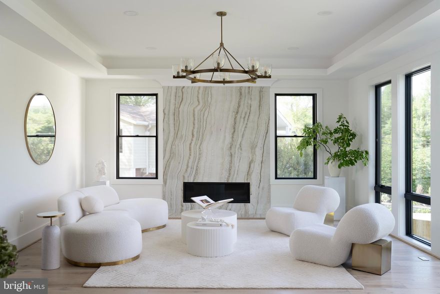 Discover unparalleled elegance with this contemporary residence built by L'avenir Custom Homes. Set on a spacious 0.46-acre lot, this exceptional property showcases meticulous craftsmanship across three beautifully finished levels.

The dramatic 20-foot foyer welcomes you into a main level designed for both everyday comfort and gracious entertaining. At its center, a gourmet kitchen showcases premium Thermador appliances, complemented by a thoughtful scullery and butler's pantry. Step outside to the motorized screened porch with its welcoming fireplace—an outdoor sanctuary for year-round enjoyment.

Upstairs, discover a welcoming lounge with private balcony. The primary retreat elevates daily living with its sitting area, two-sided fireplace, and convenient coffee bar—perfect for savoring morning views from your balcony. Every bedroom throughout the home features an ensuite bathroom and walk-in closet, including a flexible main-level suite ideal for guests or multi-generational living.

The walk-out lower level continues the home's entertaining focus with a sophisticated wet bar, media room, dedicated fitness space, and an additional bedroom suite.

With six bedrooms, six full and two half baths, a three-car garage with EV charging, and convenient access to transportation, this exceptional residence perfectly balances refined luxury with thoughtful functionality- ready to welcome you home.