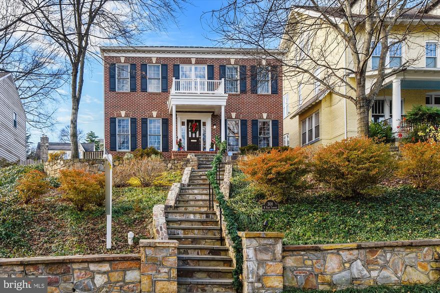 Wonderful four bedroom, four and a half bath with extra space and amenities off Russell Road - see the convenience of location without sacrificing the charm and peace of living in Rosemont, Alexandria.  A classic Colonial exterior, brick and symmetrical, with a perfectly proportioned front porch creates a powerful presence.  Gorgeous two-story foyer with a stunning chandelier opens the floor plan for guests, welcoming them in.  To the right is the formal dining room, with tall windows and chair rail, spacious enough for friends and family to eat together.  Carry on through to the open kitchen with a breakfast area suitable for picturesque family meals, a bay window backdrop and centered light fixture shape the space beautifully.  No lack of counter space to prepare meals here, it lines the kitchen along three walls with a peninsula breakfast bar.  Stainless steel appliances match the silver hardware, bringing a fresh look to the wooden cabinets.  Circle back to the foyer and enter the comfortable family room - high ceilings with windows stretching the same height elevates a cozy gathering space to a central hub of the home.  With the gas brick fireplace and French doors opening to the backyard, this room makes for a perfect second entryway to invite family inside; it leads to the detached garage off King Street.  The bright at-home office and second living room at the front of the home are down the hall, as well as a half bath convenient for guests.  Recessed lighting in almost every room adds to the natural light the windows provide.  Crown molding accentuates charm and elegance on the main and upper levels, hardwood floors throughout the main level, with carpeted bedrooms and tiled lower level.  The elegant staircase from the foyer leads upstairs to the open hall.  The primary suite was designed with privacy in mind, with several walk-in closets, a generous dressing area, and an attached bath with soaking tub, separate shower, double sinks, and a water closet, all accessible from within the bedroom.  The two additional bedrooms upstairs reside at either end of the U-shaped hall, and each have personal bathrooms.  The lower level is an entertainer's dream.  The recreation room, an excellent shape and size for a pool or foosball table, contains a conveying, top of the line shuffleboard table, and is upgraded with a wet bar at the end of the room - two beverage chillers for soda or wine and a stand-alone ice maker are below the extensive counter, complete with a full size sink.  Create your own movie theater!  The second family area converts into the perfect media room, with a built-in 4K, 3D compatible projector, a movie screen lowered at the push of a button, and DVD, BlueRay, streaming, and speaker controls set into the wall.  Seven speakers create a cinematic experience like no other.  A bonus room and exercise room bookend the full bath downstairs to the left, while the laundry room with counter space and a spacious storage area line the right.  At the W Braddock entrance, this home sits atop a hill, tiered by stone retaining walls. The King Street entrance is discreet, prominently featuring the two-car garage, with steps down the back to enter the home.  Storage under the garage is spacious, and consolidates space in the backyard, allowing for a pleasant patio and play area for entertaining.  Del Ray's main street, Mount Vernon Avenue, is five blocks away and Old Town is half a mile, a 10-minute walk to shops, dining, and more.  Commuters can easily access the Blue or Yellow lines from King Street Metro Station, an 8-minute walk from this home.  For further travel, Alexandria's Amtrak Train Station is the same distance.  I-395 access is right down King Street.