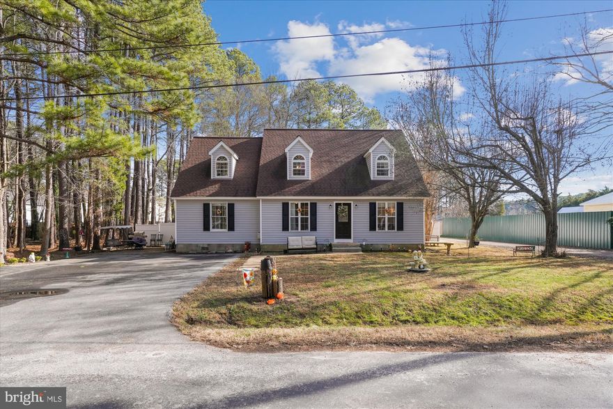 Welcome to this inviting Cape Cod home, move-in ready and just a block from the scenic St. Mary's River, offering community fishing and boat access. Known for its picturesque tall pines, the area provides a serene backdrop to this 5-bedroom, 2.5-bathroom residence, which offers over two thousand square feet of living space on an 11,600 square foot fully fenced lot.

The main section of the home includes 4 bedrooms—three upstairs, including the primary bedroom suite, and one on the ground floor. The spacious eat-in kitchen features an island and stainless steel appliances, with easy access to the backyard deck for seamless indoor-outdoor living. The self-sufficient in-law suite, with its own entrance, full kitchen, and bathroom, provides excellent potential for rental income or multi-generational living. The conveniently located laundry room serves both living areas with ease.

Additional features include a detached two-car garage with bonus space and a driveway that accommodates four vehicles. Just minutes from Piney Point Lighthouse Park and beach, this home offers a fantastic opportunity to embrace coastal living. Don’t miss out!