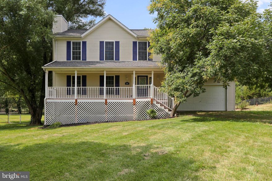 Room to grow! This peaceful property sits at the end of a road in a neighborhood bordered by farmland, but within minutes of Routes 9 & 81. Enjoy countless hours relaxing by the stocked koi pond with a waterfall. Harvest your next meal, or hops for your home-brew, from the large fenced garden and fruit from the pear and peach trees. The area around the house is fenced and ready to keep your furry friends contained. Chickens and goats are permitted. Survey it all from the deck just off the kitchen, the covered front porch, or from the walkout basement.  The main level of the home offers a family room with a cozy wood-burning fireplace. Keep track of everything on the chalkboard wall in the dining room (that would also be a great classroom). Enjoy making meals in the happy kitchen with a butcher block topped island, table space, and a large pantry. The basement holds a recreation room complete with a wet bar, a pellet stove, an office area/game room, and the laundry room. Upstairs are 3 nicely sized sunny bedrooms. The primary suite has a recently renovated bathroom that includes a glass-walled, walk-in shower with rainhead and a floating vanity. The oversized garage has workshop space and fantastic storage areas. The roof was replaced in 2021. Water softener replaced April 2022. Seller had DSL with Frontier for internet.