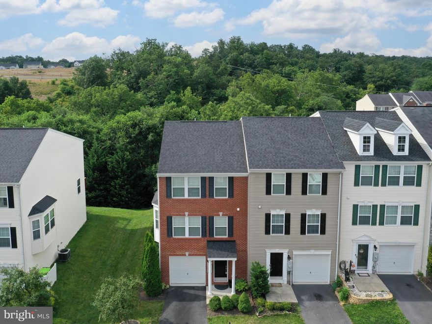 Welcome to this stunning 3-bedroom, 2 full bath, 2 half bath end unit townhome! This beautiful brick-front residence boasts an array of features that cater to both comfort and style. Let's take a closer look at what makes this property a true gem:

Newer Updates:  Newer Roof (Approx. 2021), New HVAC (2023), Interior Paint (Approx. 2022), New driveway when seller bought, seller also added a larger kitchen Island.  

Prime Location: Nestled in a desirable neighborhood, this end unit townhome offers both convenience and serenity. With trees in the backyard providing a natural backdrop, you'll find yourself immersed in a peaceful oasis.

Modern Kitchen: The heart of the home, the kitchen, is a true masterpiece. Its spacious layout and very large island with elegant granite countertops offer an ideal space for culinary adventures and entertaining. Equipped with stainless steel appliances, the kitchen is perfect for those who love to cook and indulge in delicious meals.

Comfortable Living Spaces: With both a family room and a separate living room and a second family room on the main level this townhome provides ample space for relaxation and entertainment. The family room off the kitchen creates a cozy atmosphere for casual gatherings, while the living room offers a more formal setting for special occasions.

Seamless Indoor-Outdoor Living: Step onto the large deck from the kitchen/family room and enjoy a seamless blend of indoor and outdoor living. The deck is perfect for outdoor dining, hosting barbecues, or simply unwinding with a cup of coffee while enjoying the natural surroundings.

Luxurious Primary Suite: Upstairs, the primary suite awaits with its tray ceiling, walk-in closet, and a large full bath. This private retreat is designed to provide comfort and tranquility, ensuring you have a peaceful haven to relax and recharge.

Versatile Main Level: The main level is truly multi-functional, offering a wide range of possibilities. With an oversized garage providing ample storage space, an office area for those who work from home, and a second family room for various activities, this level is thoughtfully designed to accommodate all your needs.

Convenient Half Baths: The strategically placed half baths on both the kitchen and main levels provide added convenience and comfort for you and your guests.

Laundry Room: The inclusion of a dedicated laundry room adds practicality and convenience, making day-to-day chores a breeze.

Walk-out to Backyard: From the main level, you have direct access to the backyard, making it easy to enjoy outdoor activities and the beauty of nature.

Don't miss the opportunity to call this remarkable townhome your own. Whether you're seeking a harmonious family abode or a place to entertain and create cherished memories, this property has it all. Schedule a viewing today and experience the lifestyle this home has to offer!
